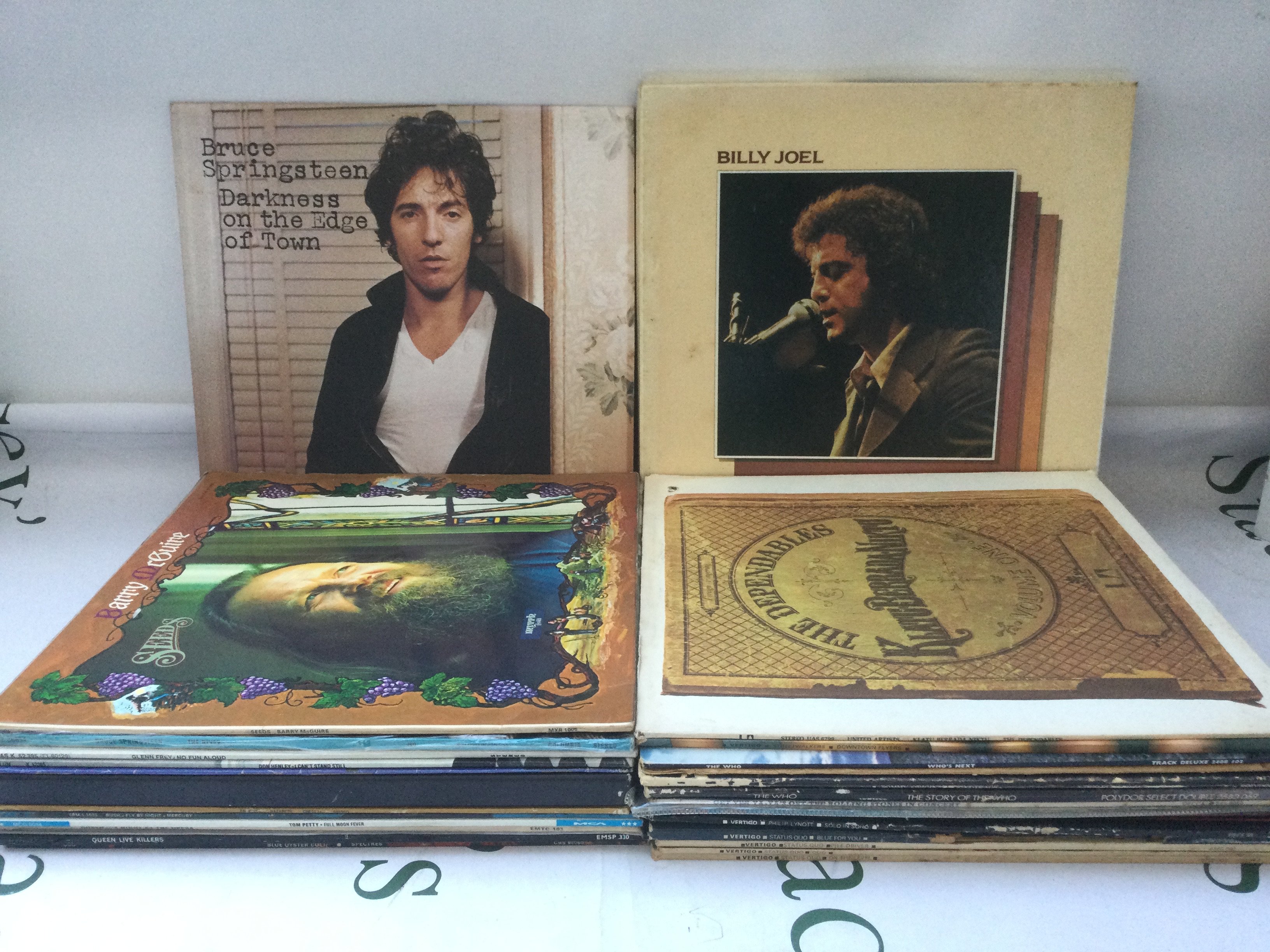 Thirty rock LPs by various artists including The Who, Bruce Springsteen, Queen and others.