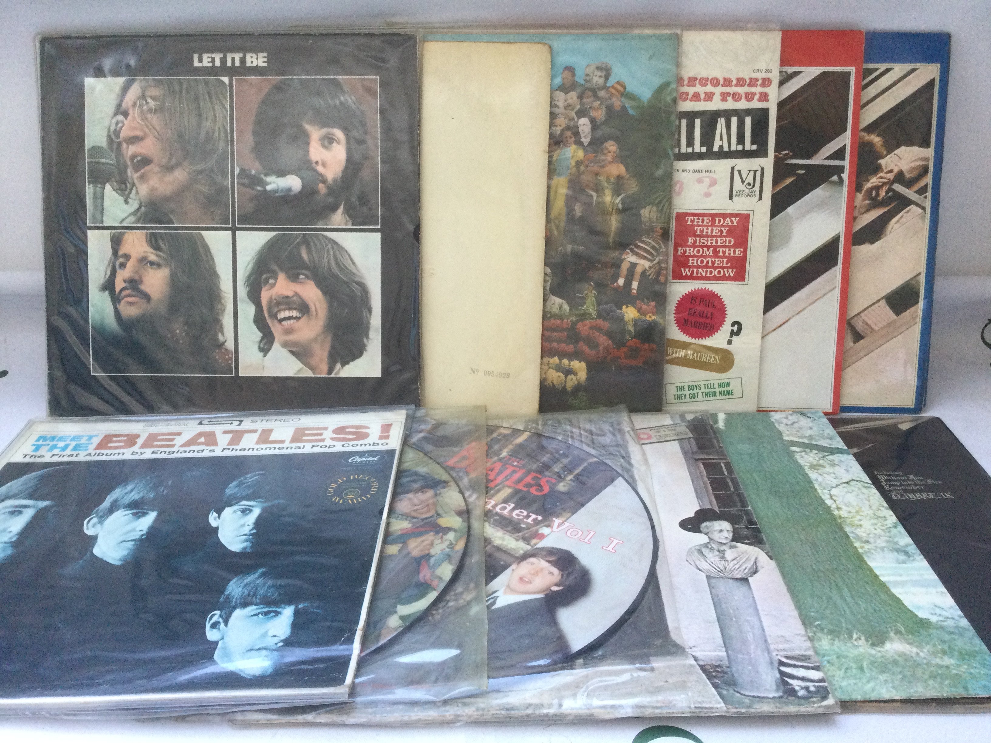 Twelve Beatles and related LPs including a numbered 'White Album' 0054928 (no inserts), Let It Be, Plastic Ono Band and others, includes US pressings.