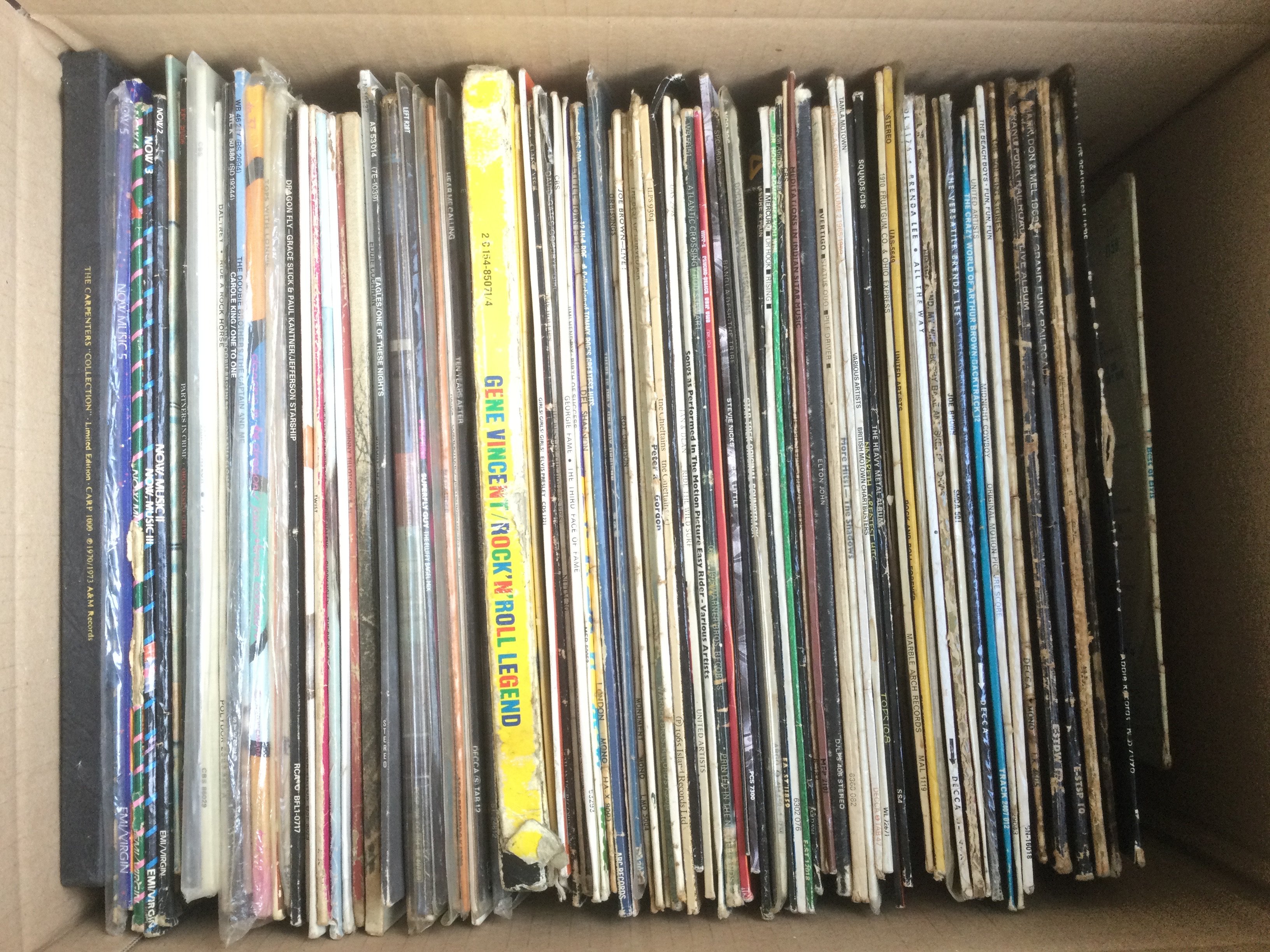 A box of LPs and 12" singles by various artists including The Beatles, Grand Funk Railroad, Gene Vincent and many more.