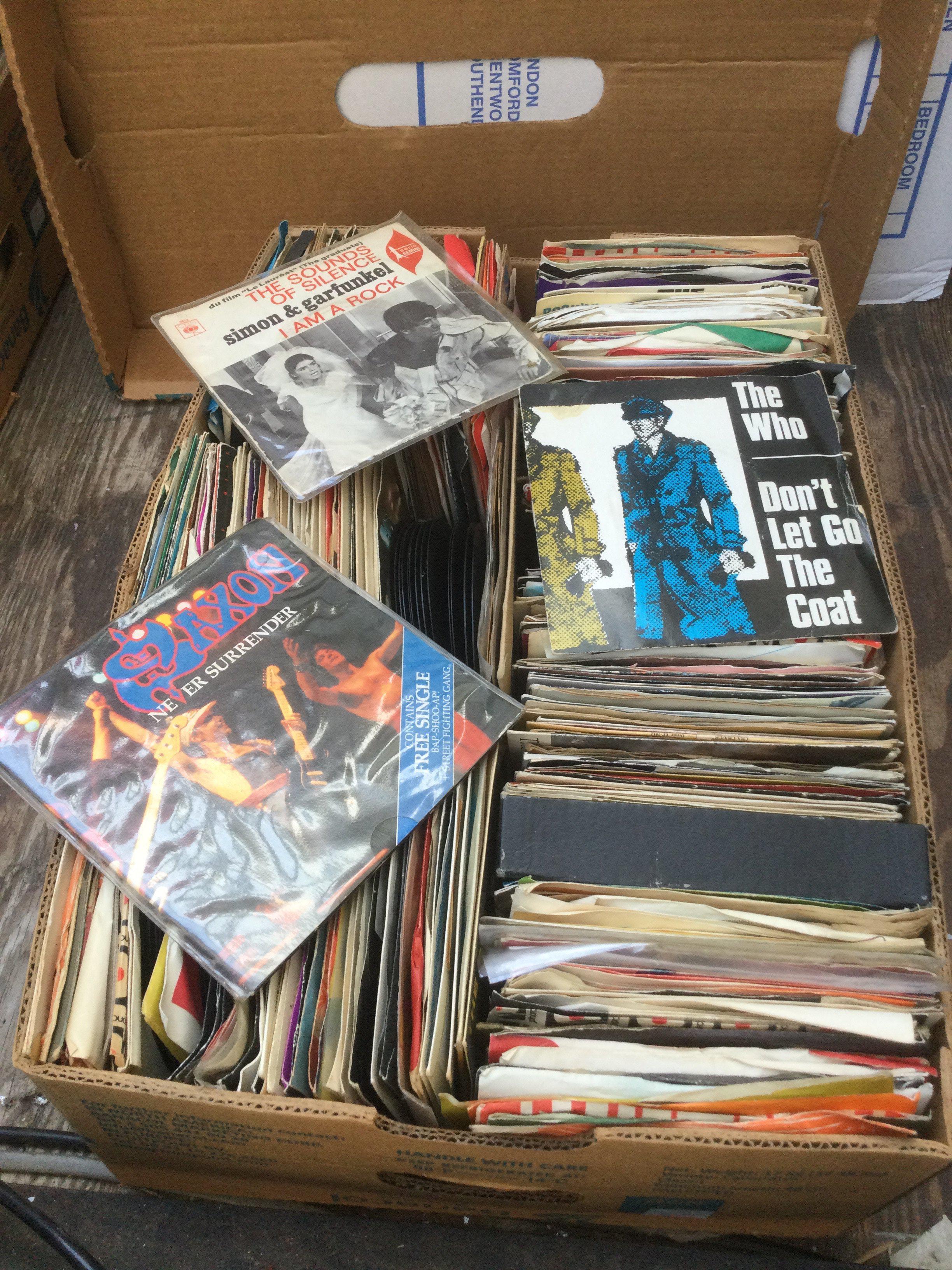 Two boxes if 7" singles and EPs by various artists including The Beatles, The Who, Iron Maiden and many more. Includes some promo discs.