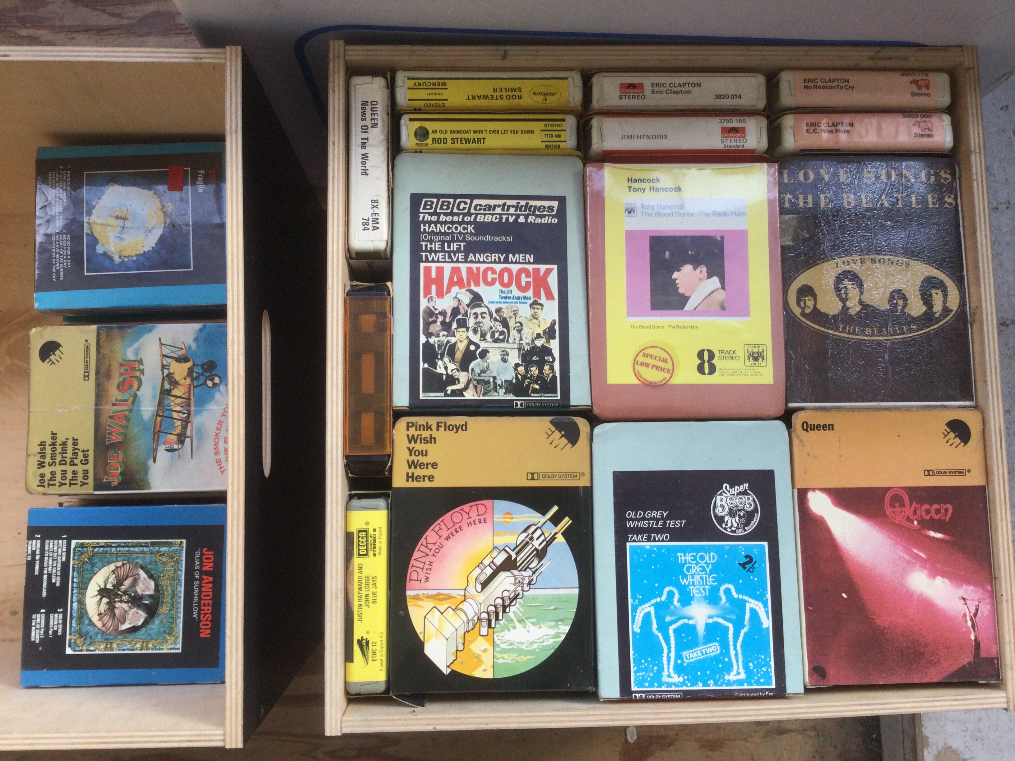 Two boxes of 8 track cartridges and a Pioneer 8 track machine. Artists include The Beatles, King Crimson, David Bowie, Pink Floyd and others. For a full list see images.