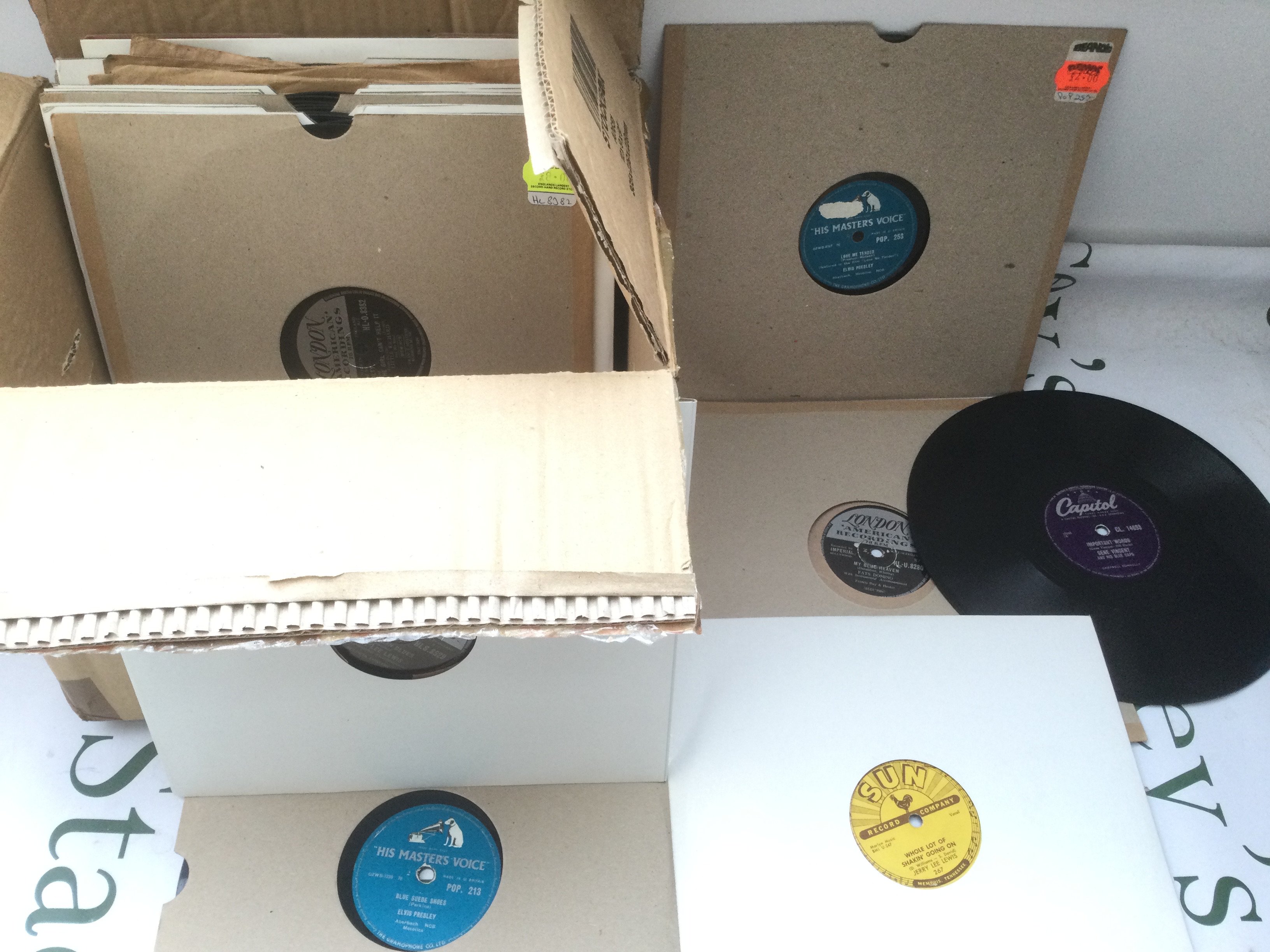 A collection of rock n roll 78s by various artists including Elvis Presley, Jerry Lee Lewis, Gene Vincent and others.