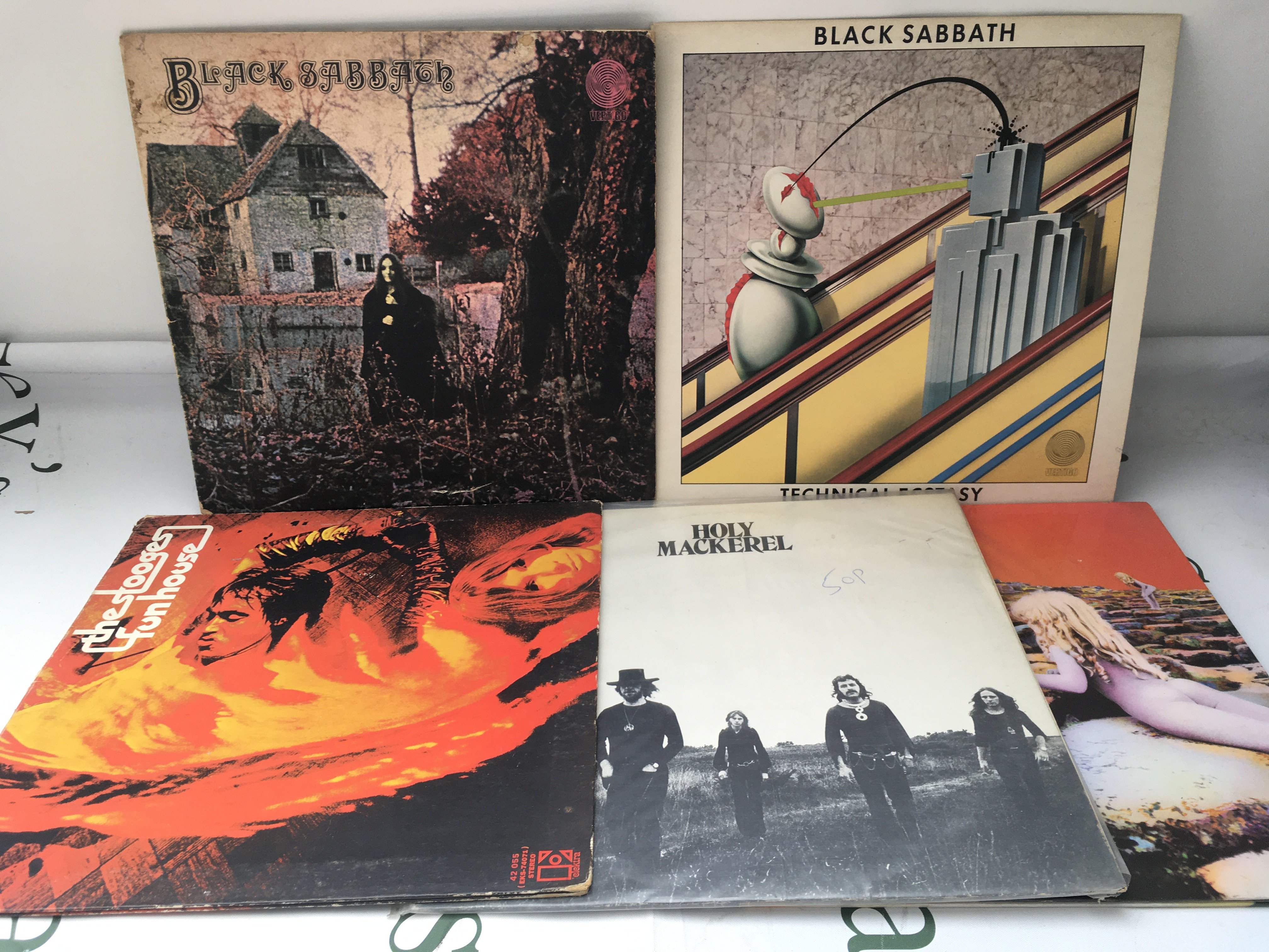Five rock LPs by various artists including Black Sabbath, The Stooges, Led Zeppelin and Holy Mackerel.