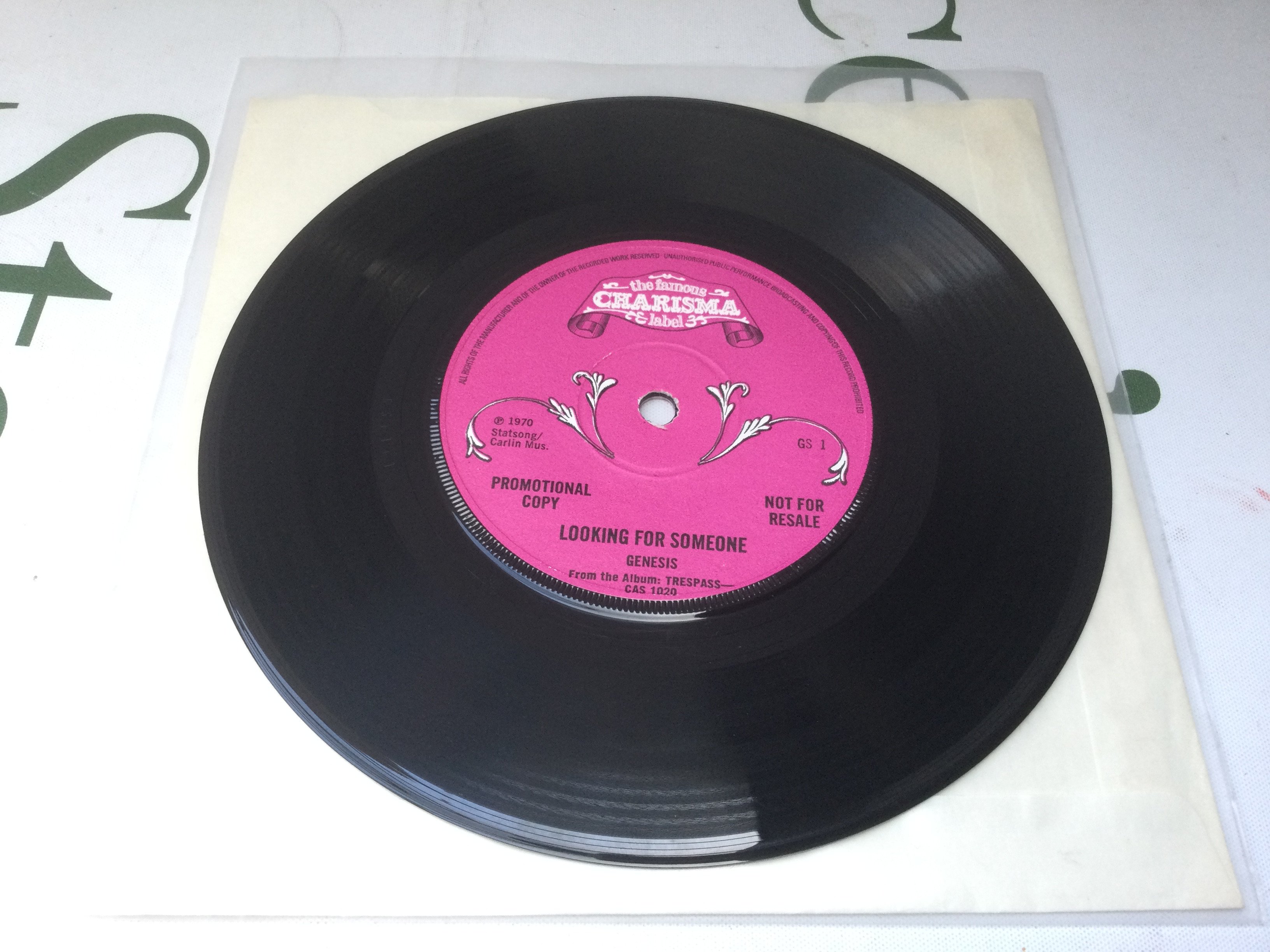 A rare Genesis promotional disc of 'Looking For Someone' b/w 'Visions Of Angels' given away to radio stations and members of the press to promote the 1970 'Trespass' LP. Solid centre with rough textured pink scroll Charisma labels. Matrices 65+1+1 and 65+2+1. Hard to find in such exceptional condition.