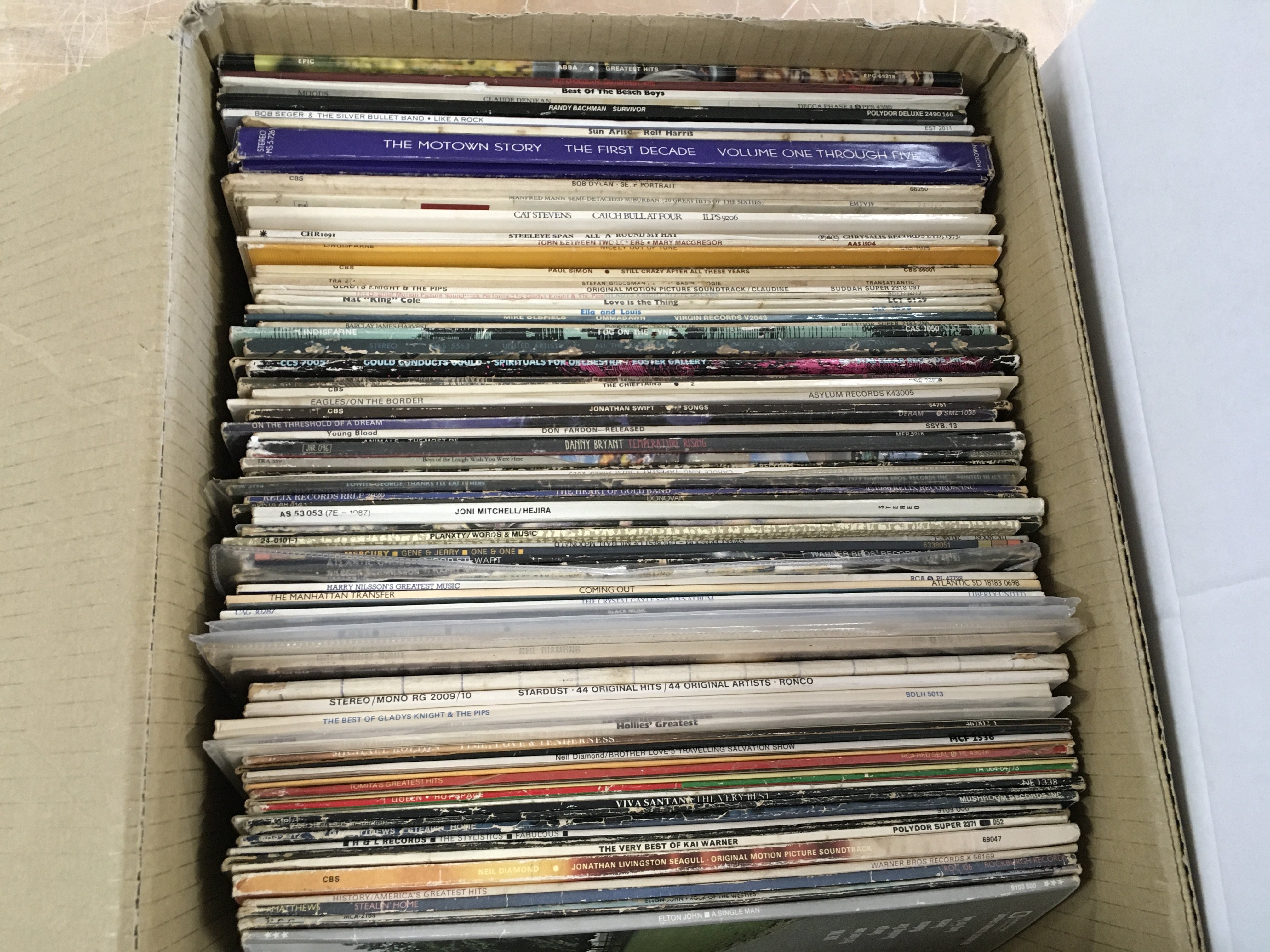 A box of LPs by various artists including Pink Floyd, Jethro Tull, Bob Dylan and others.