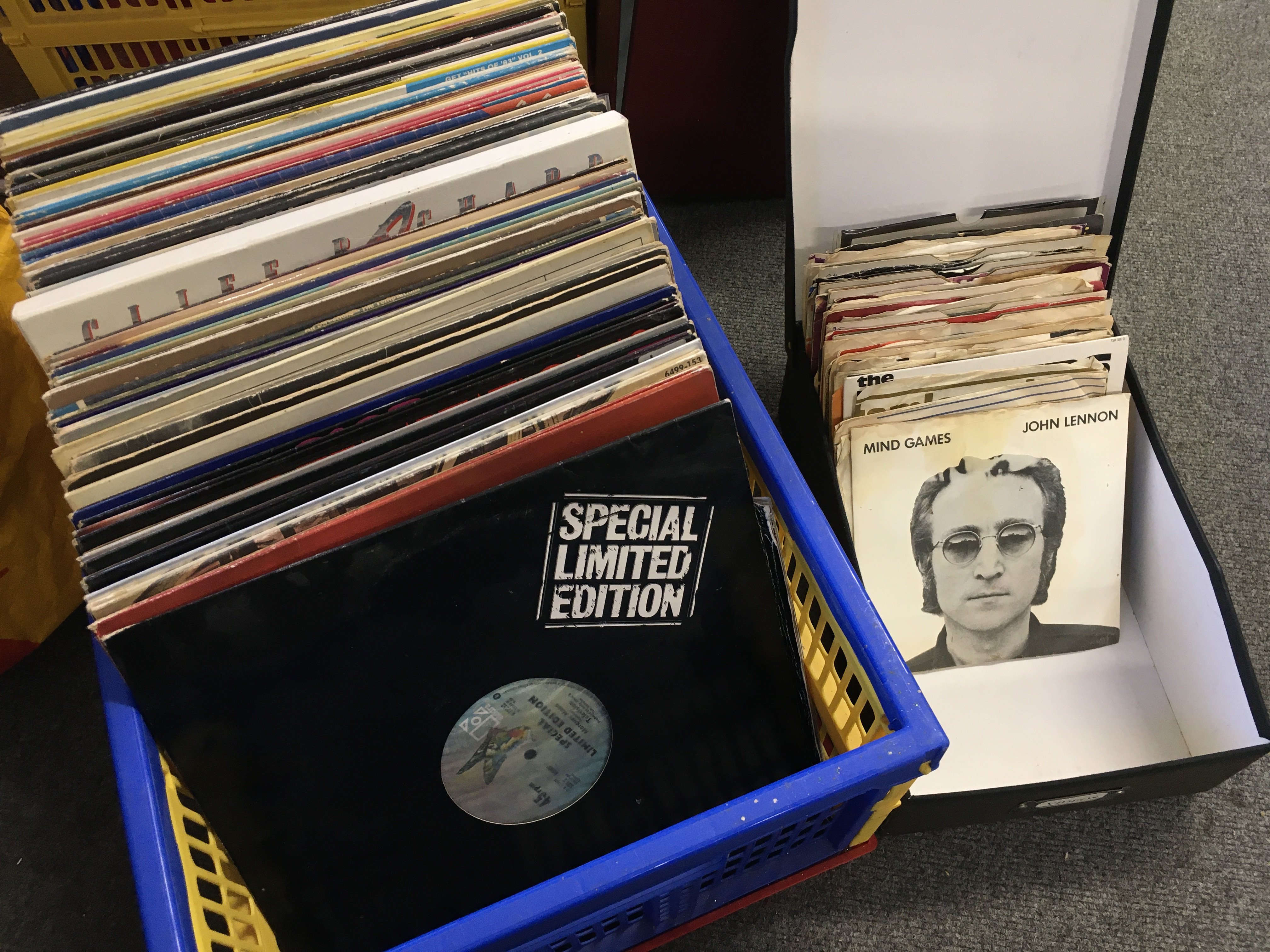 A box of LPs, 12" and 7" singles by various artists including Alice Cooper, Television, The Who and others. Also includes some 7" single paper sleeves.