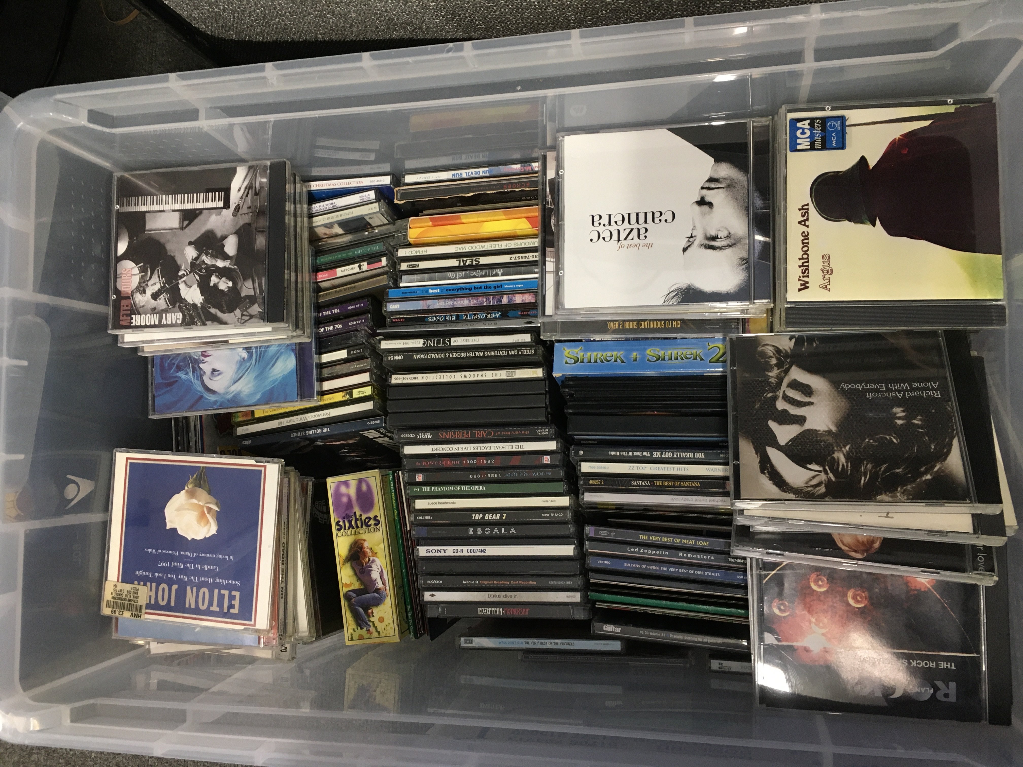 A large box of CDs by various artists including Paul Weller, Supergrass, Led Zeppelin and many more.