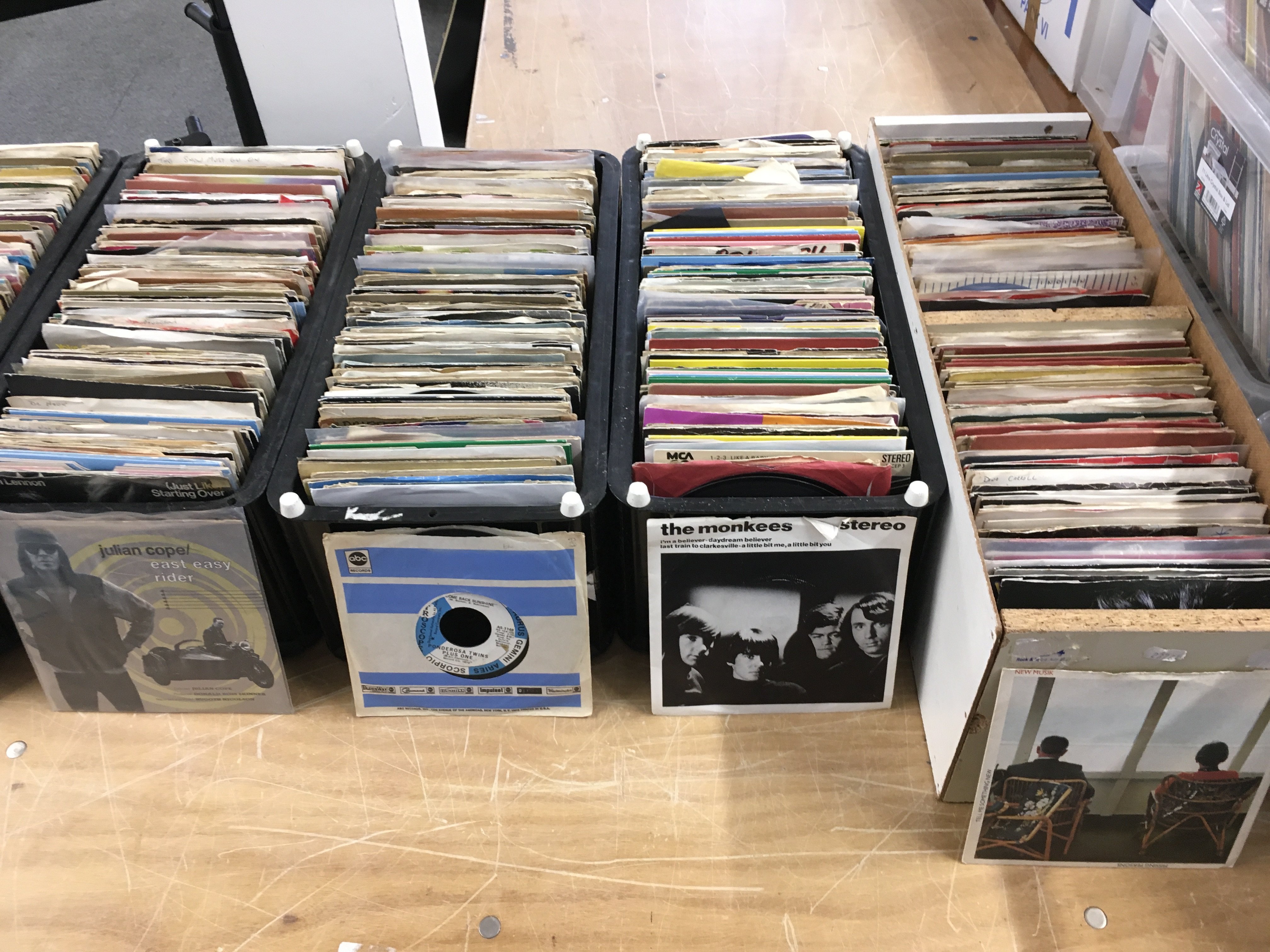 Five boxes and six record cases of 7" singles by various artists from the 1960s onwards.