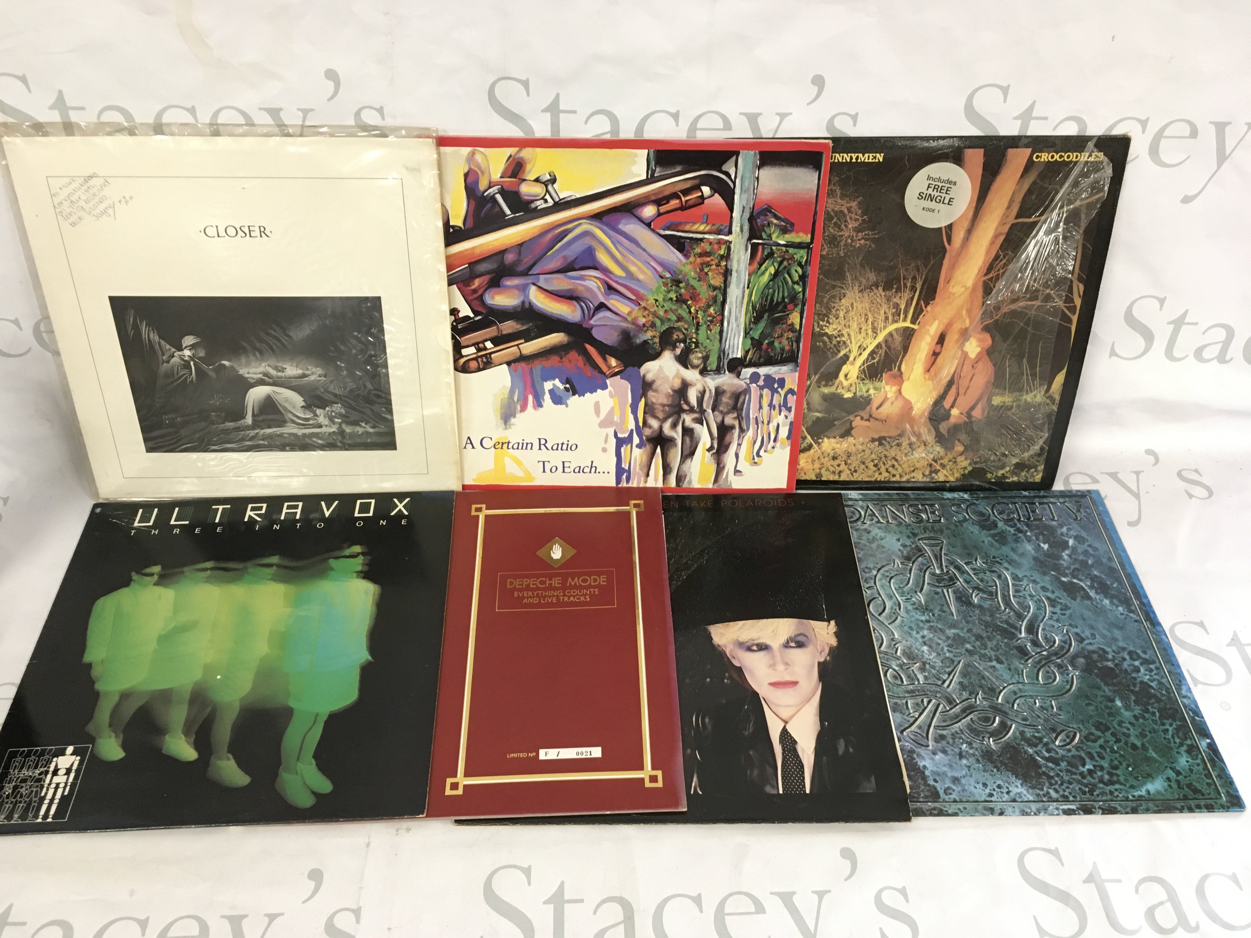 Two bags containing 20 post punk and new wave LPs and 12" singles by various artists including Joy Division, Echo & The Bunnymen, The Danse Society and others.