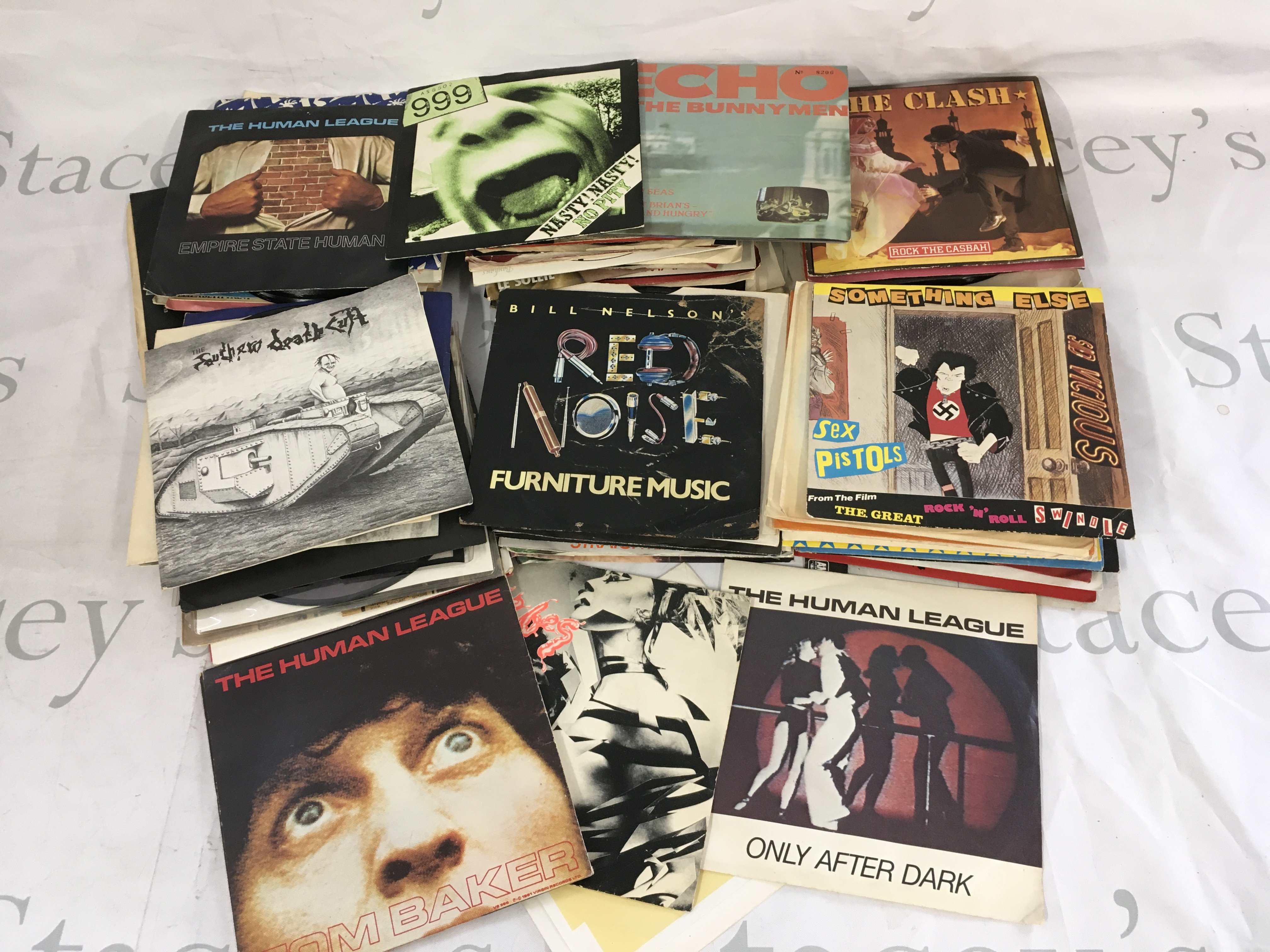 A collection of 7" singles and EPs by various artists including PiL, Southern Death Cult, Sex Pistols and others.