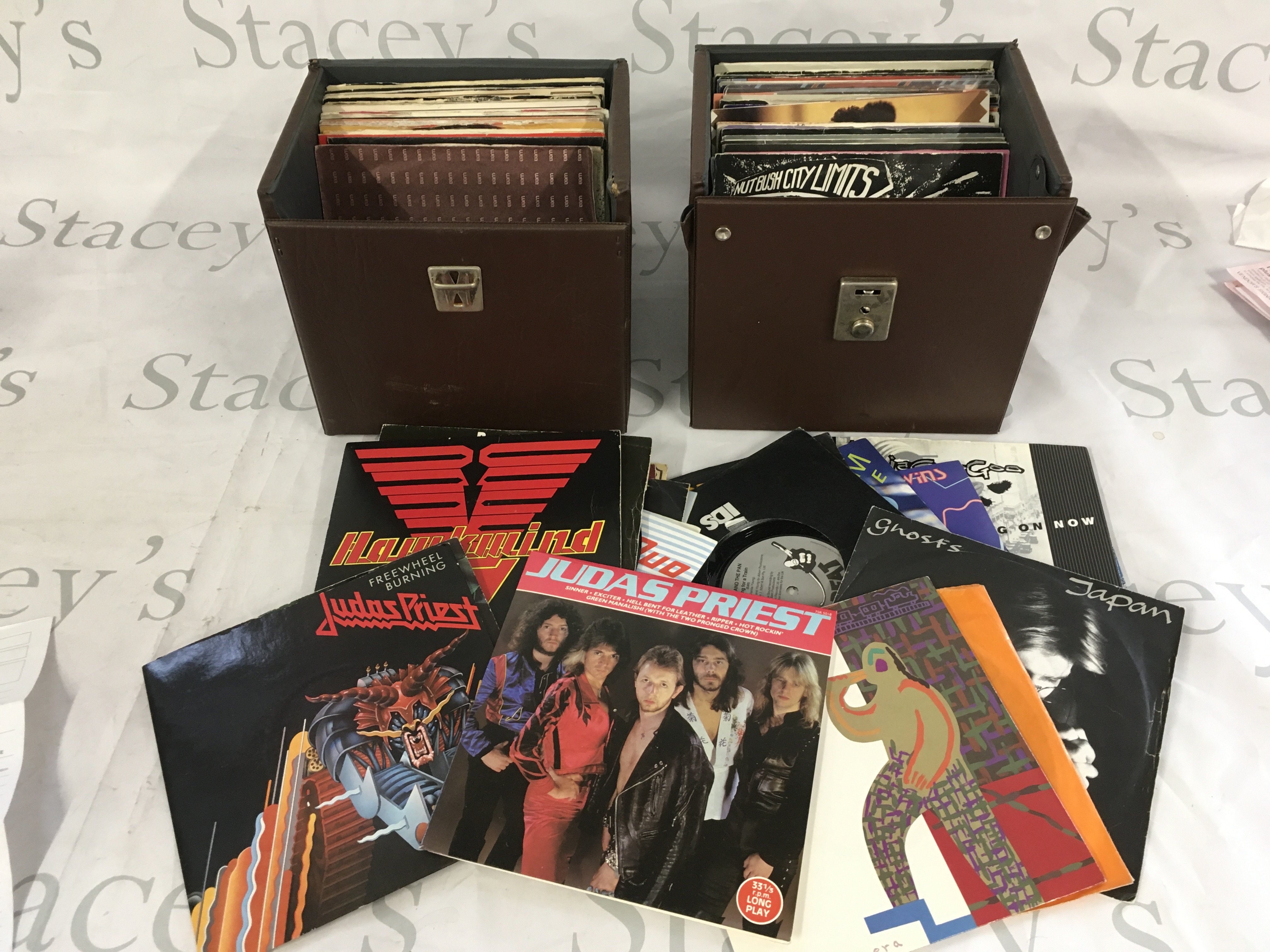 Four record cases of 7" singles and EPs comprising mainly 1980s rock and pop artists.