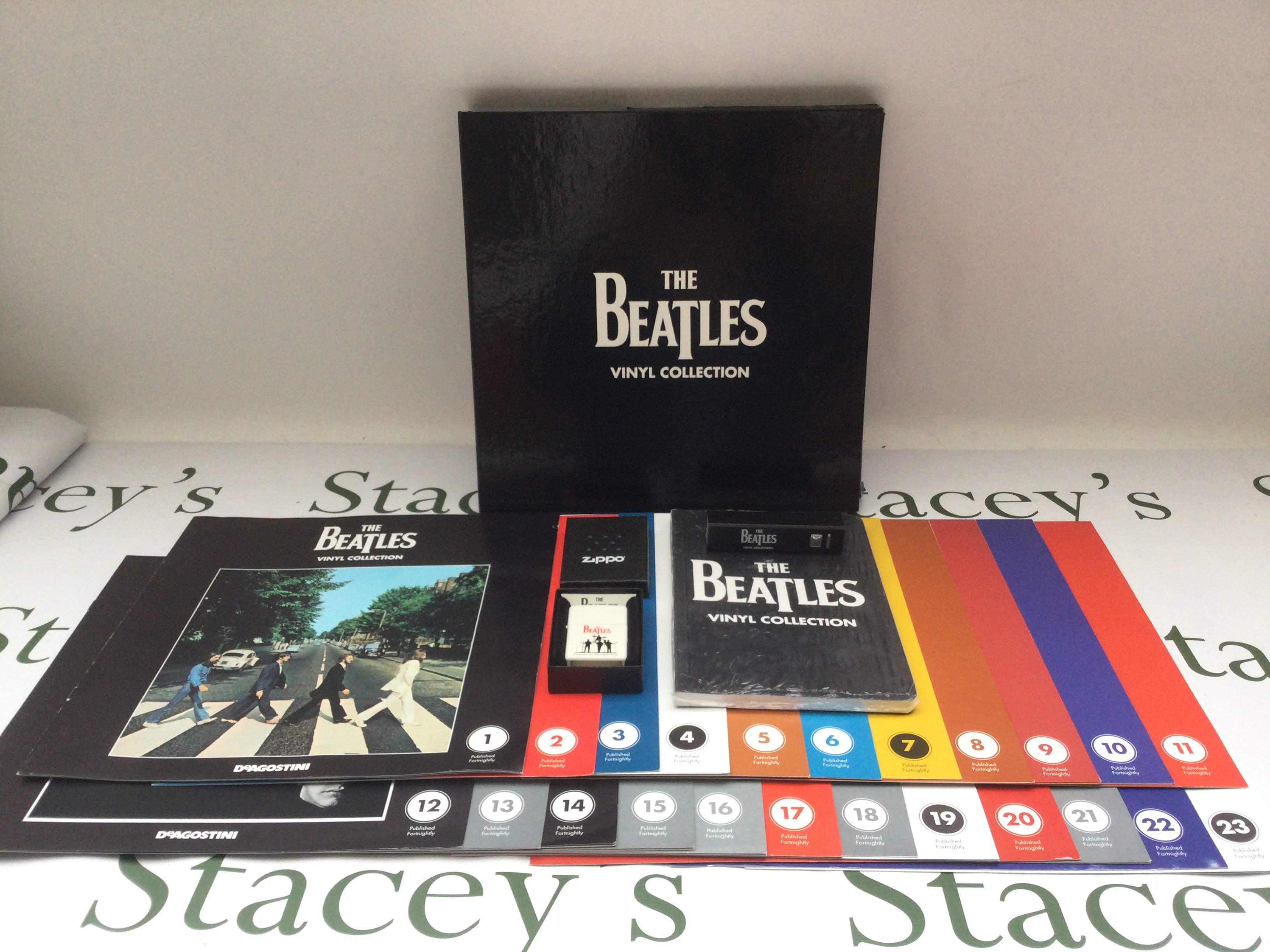 A complete Beatles DeAgostini 180g LP collection with inserts, a USB power bank and a boxed Beatles zippo lighter.