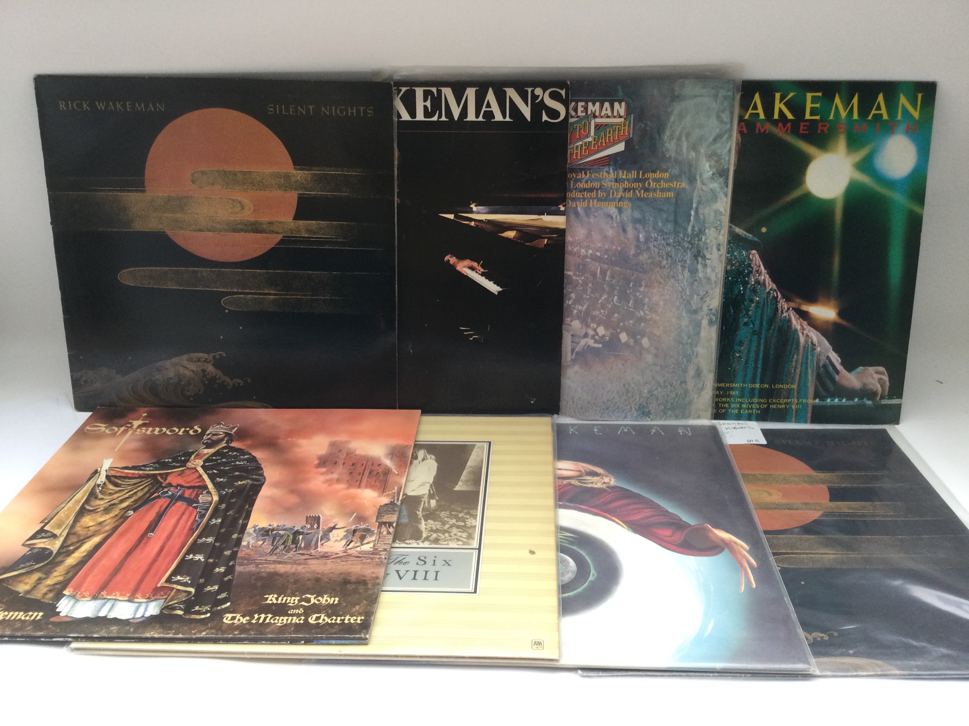 Two bags containing 16 Rick Wakeman LPs comprising 180g vinyl and original pressings.