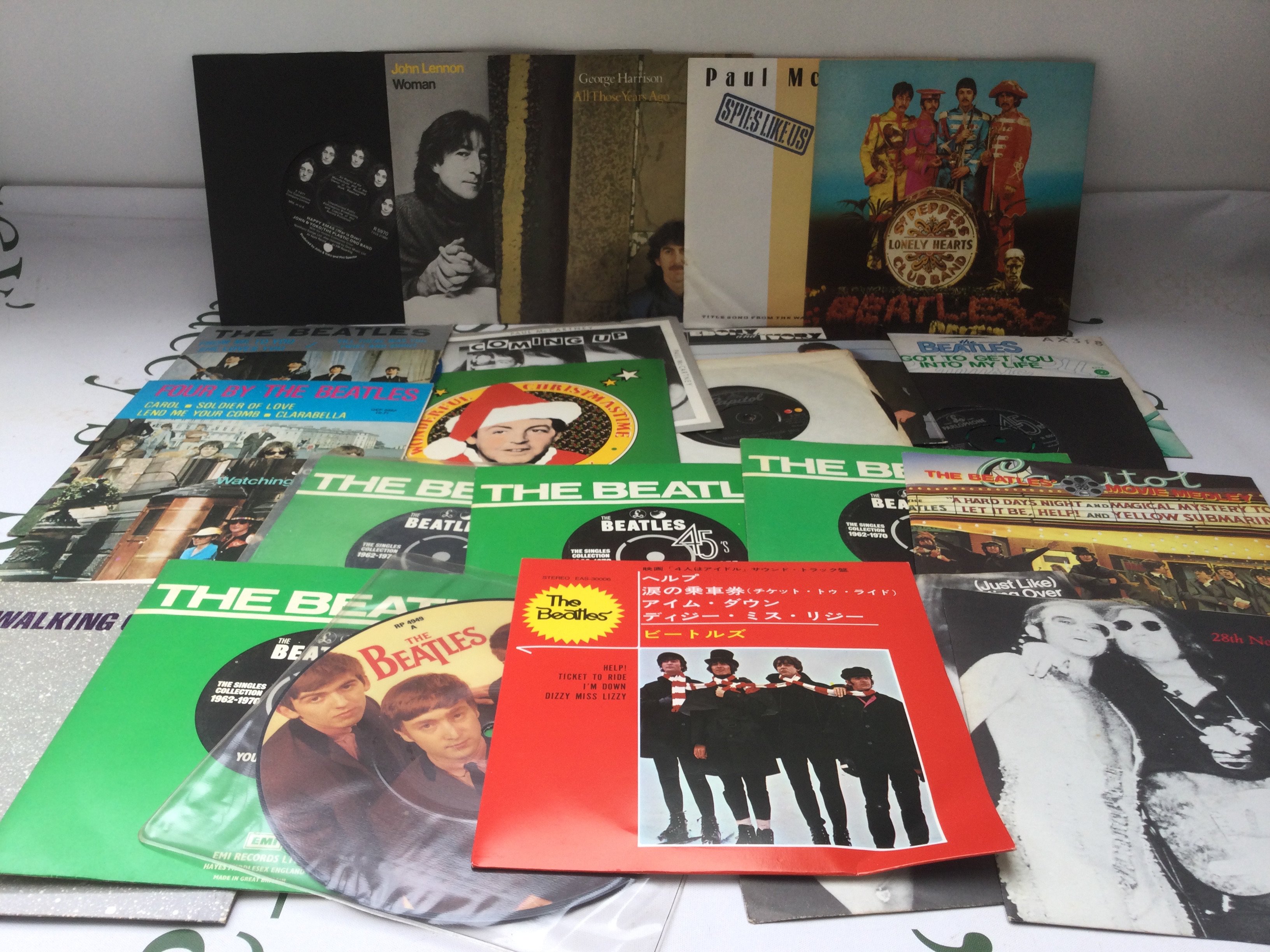 A collection of Beatles and solo 7" singles and EPs.