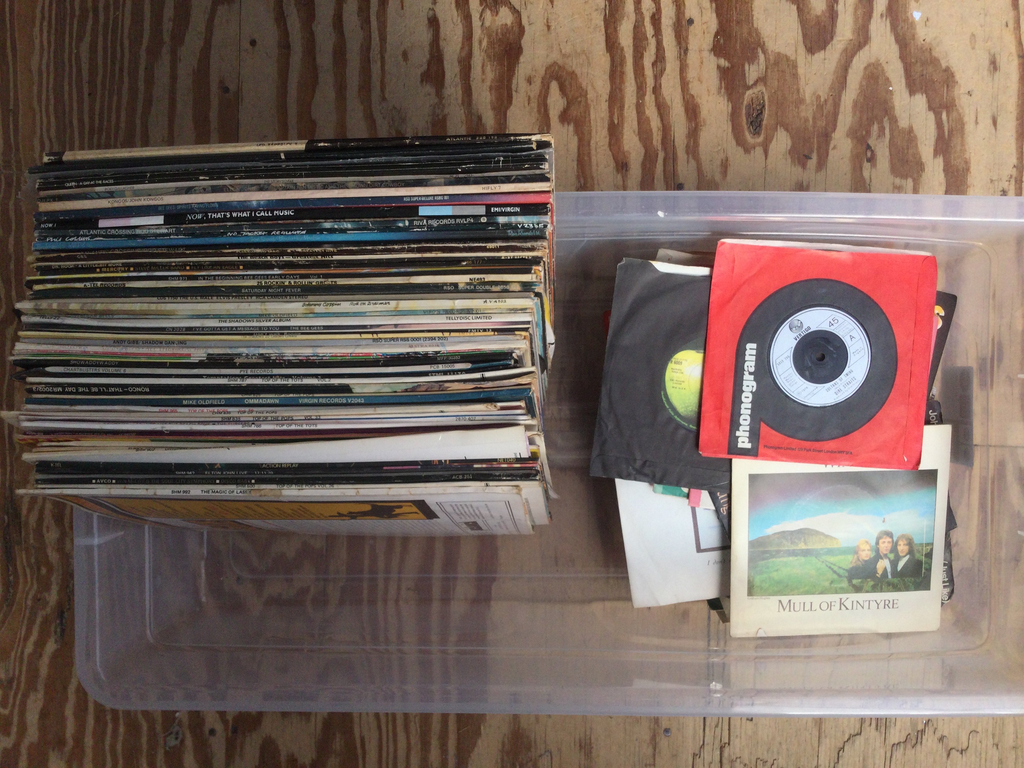 A box of LPs and 7" singles by various artists including Led Zeppelin, Pink Floyd, Queen and many more.