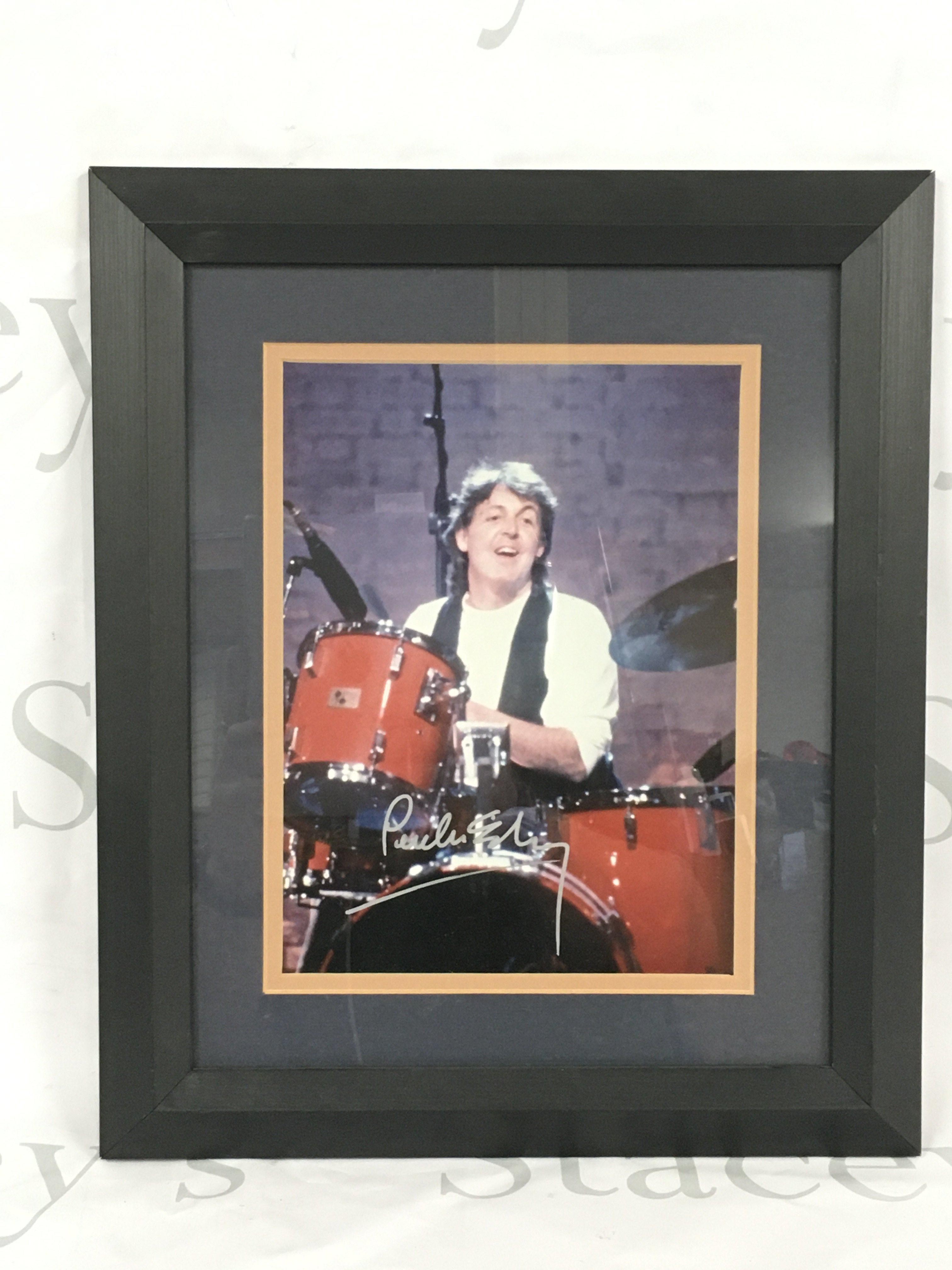 A signed photo of Paul McCartney with COA.