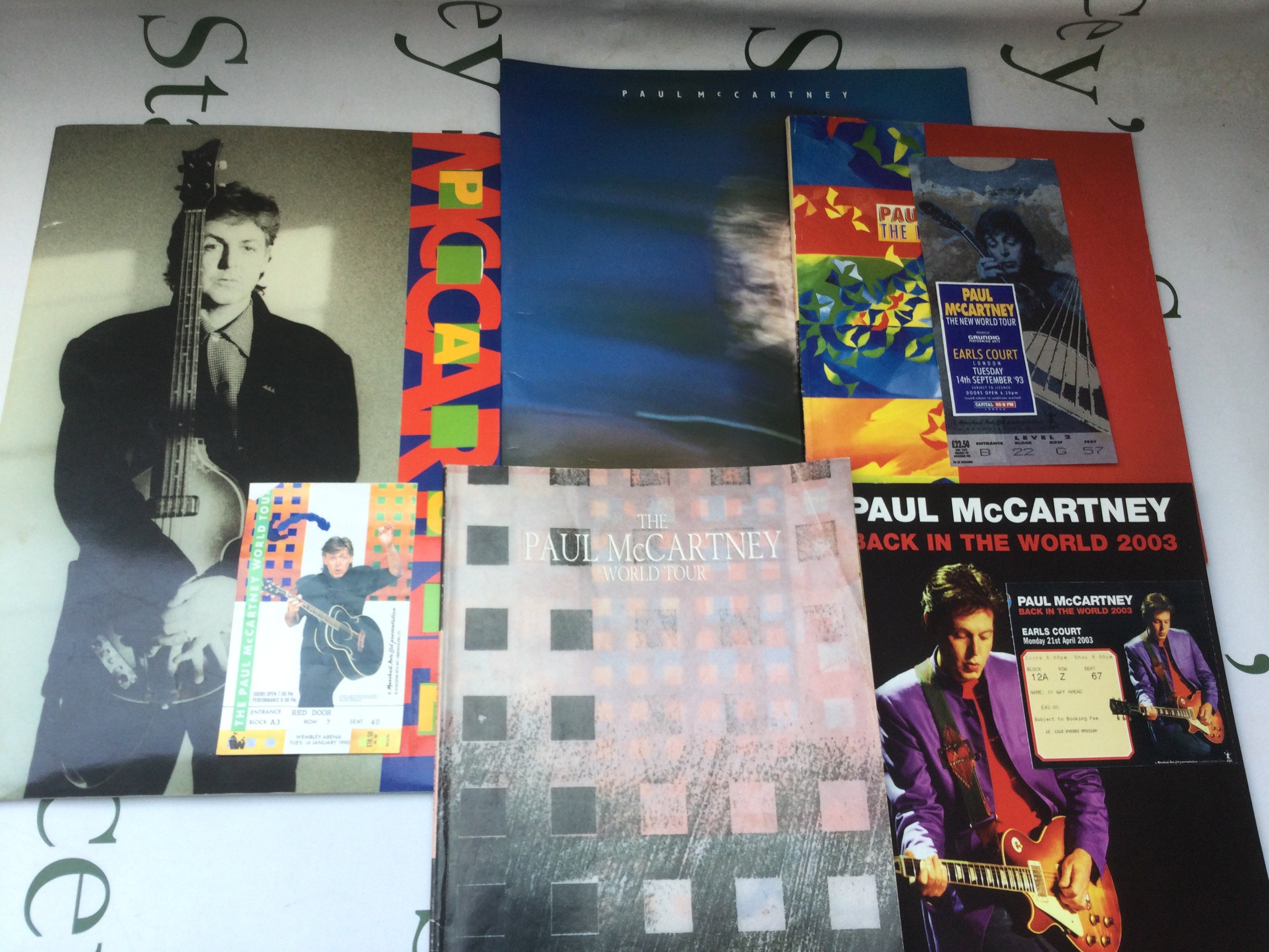 Five Paul McCartney tour programs, three with tickets.