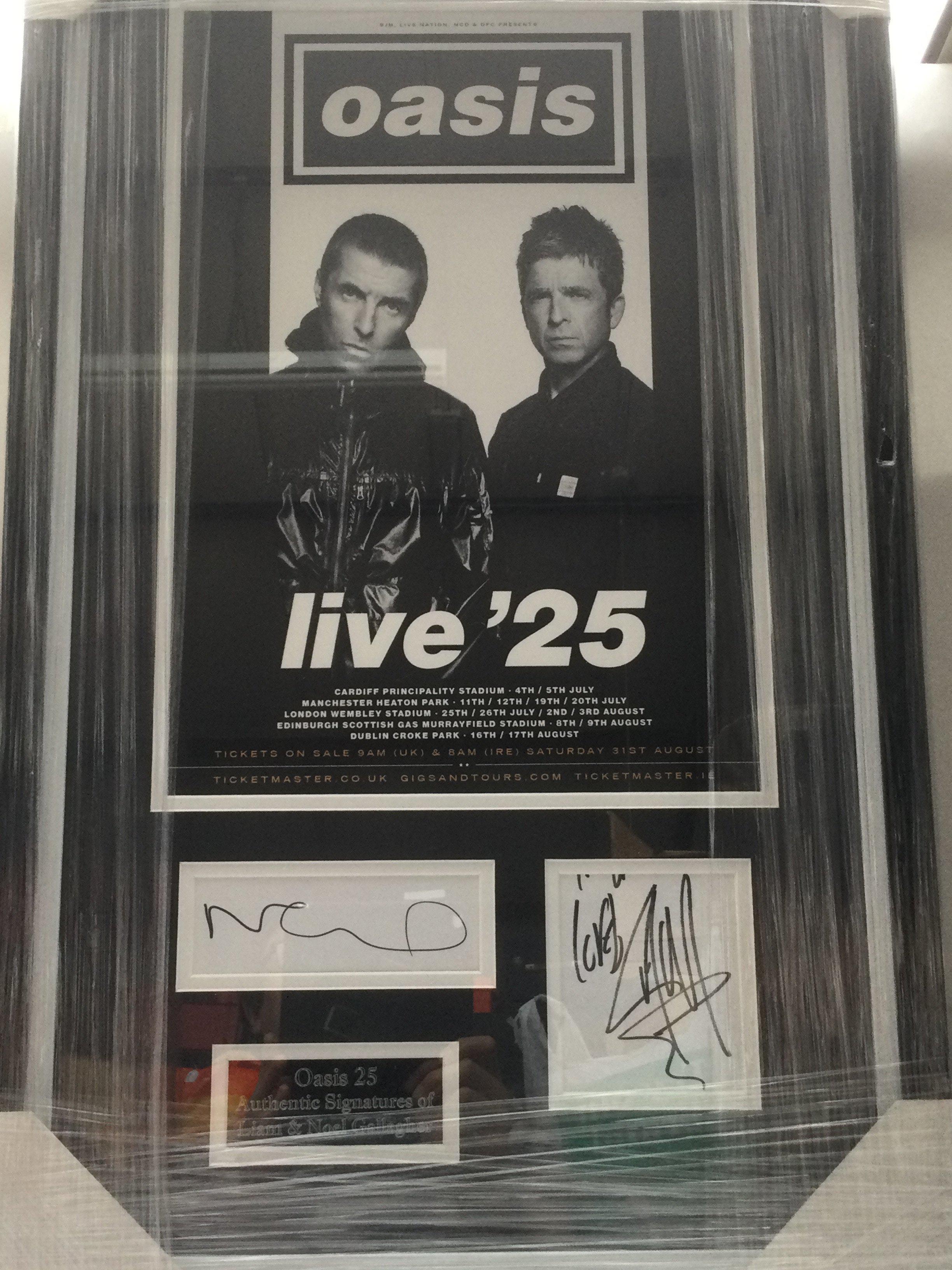 A framed and glazed Oasis '25 display signed by Liam and Noel, approx 72cm x 44cm.