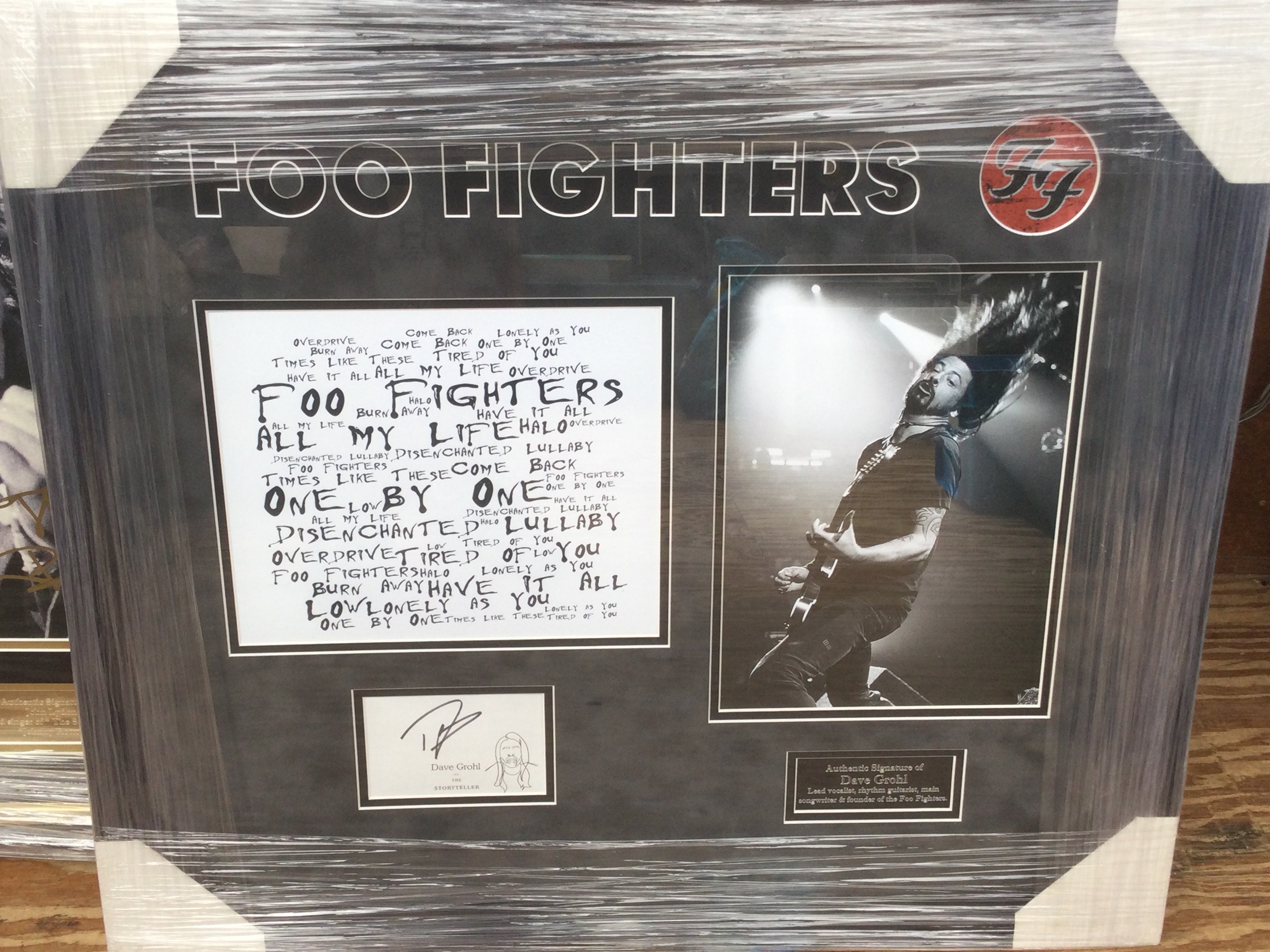 A framed and glazed Foo Fighters display signed by Dave Grohl with COA, approx 58.5cm x 66cm.
