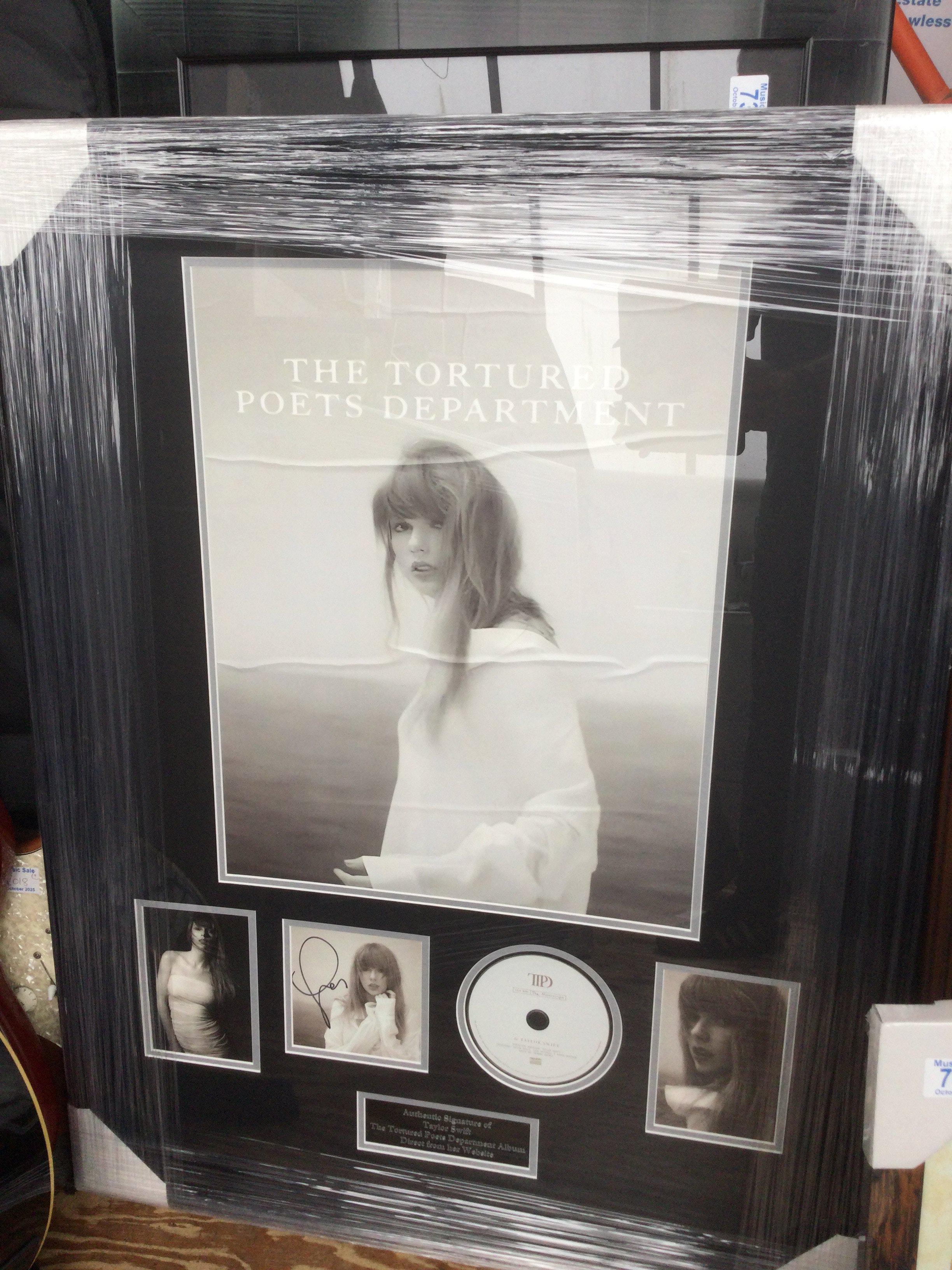 A framed and glazed signed Taylor Swift display of The Tortured Posts Department, approx 92.5cm x 70cm.