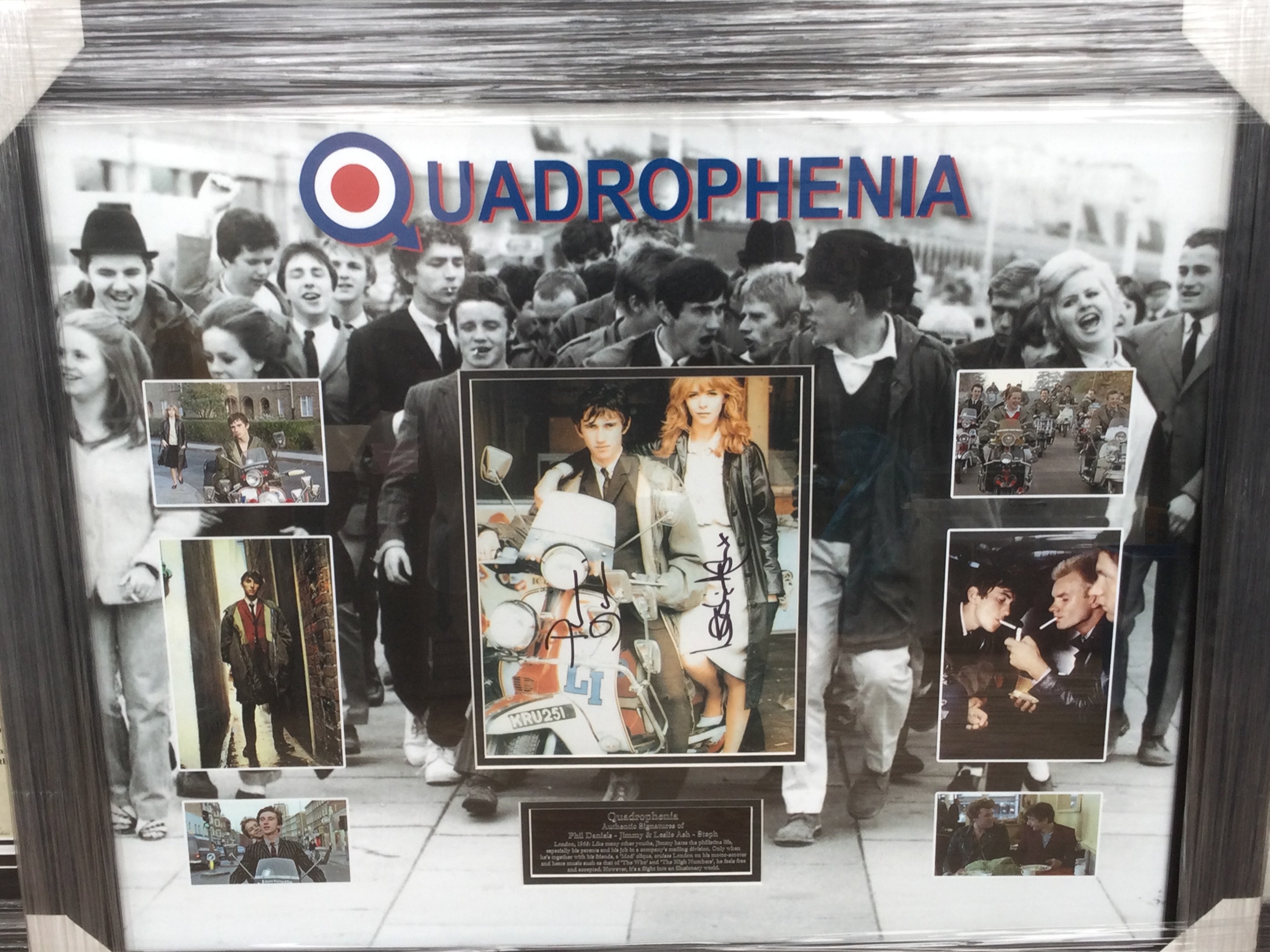 A framed and glazed display of Quadrophenia signed by Phil Daniels and Leslie Ash with COA, approx 66cm x 79cm.