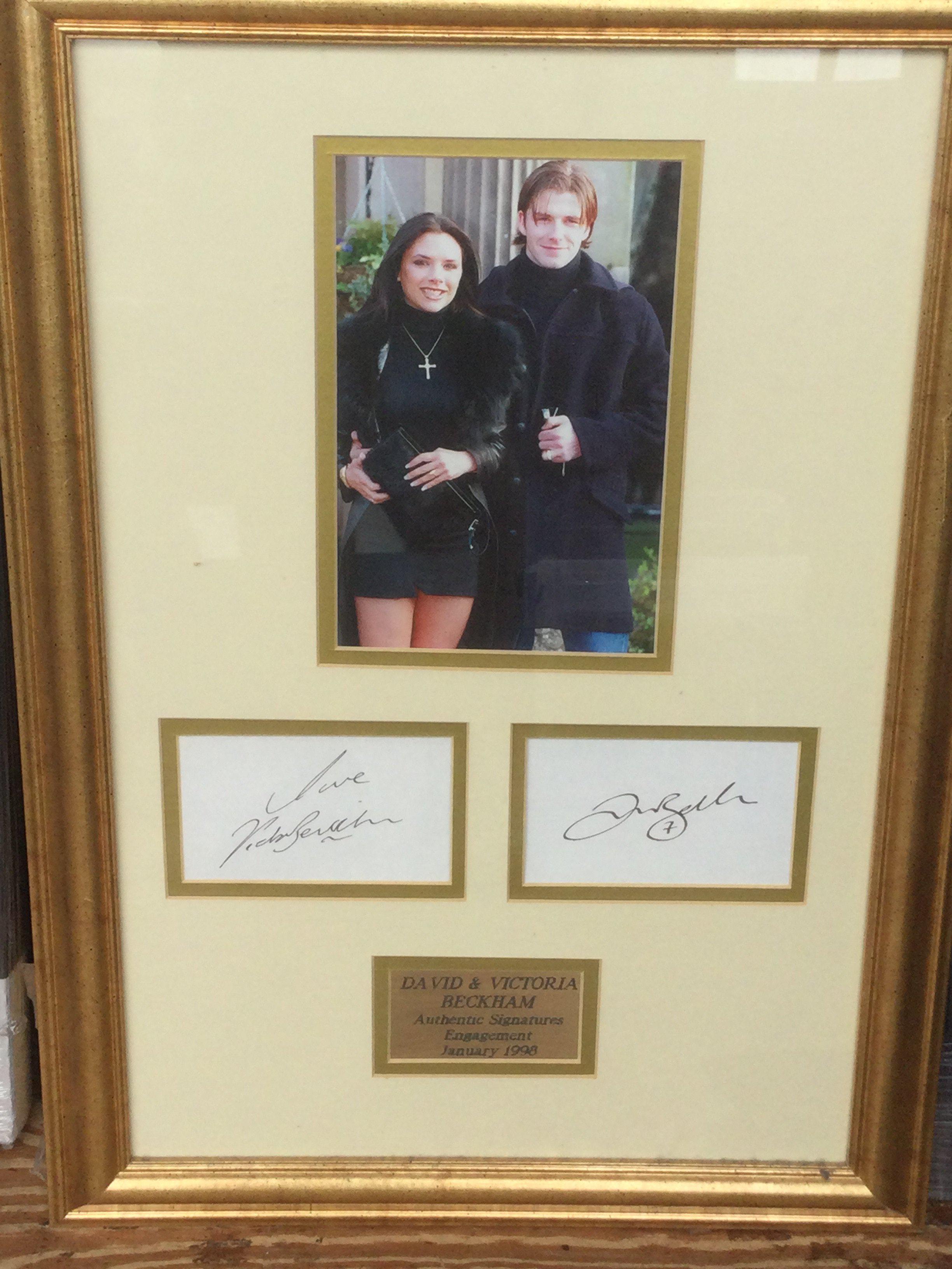 A framed and glazed signed display of David and Victoria Beckham, approx 61cm x 43cm.