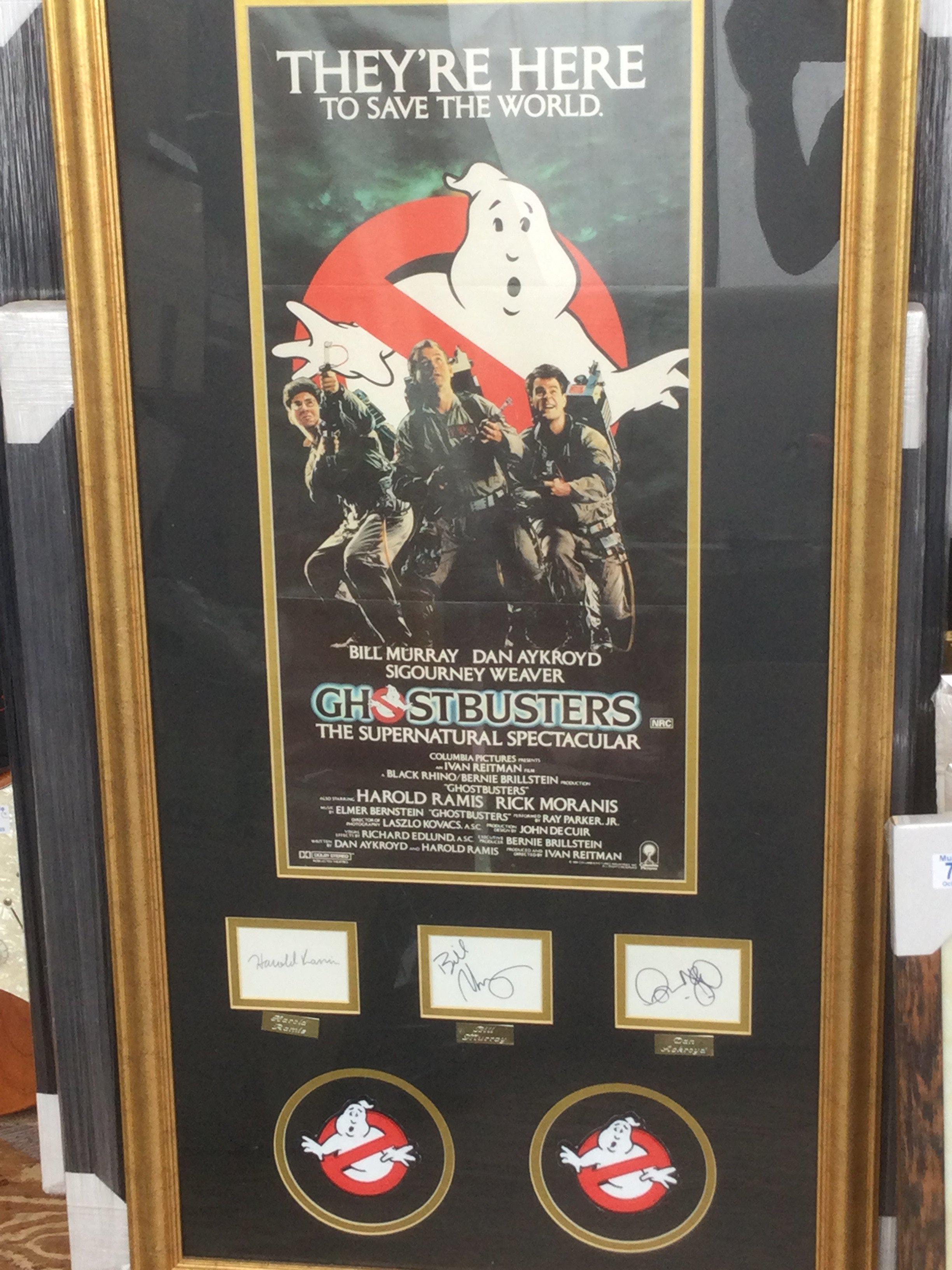 A framed and glazed Ghostbusters display signed by Bill Murray, Dan Ackroyd and Harold Ramis with COA, approx 110cm x 59cm.