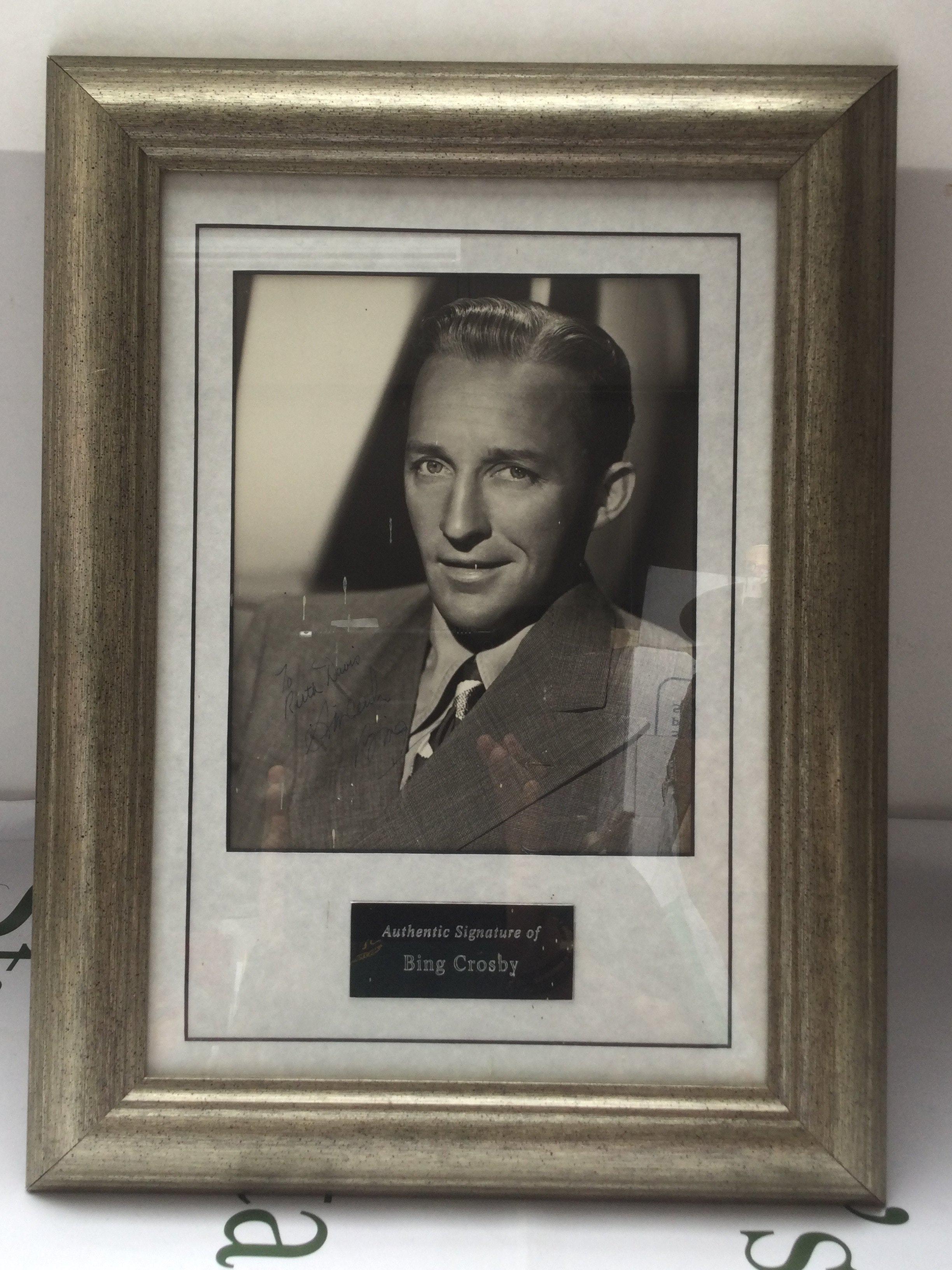 A framed and glazed signed Bing Crosby display with COA, approx 34cm x 45cm.