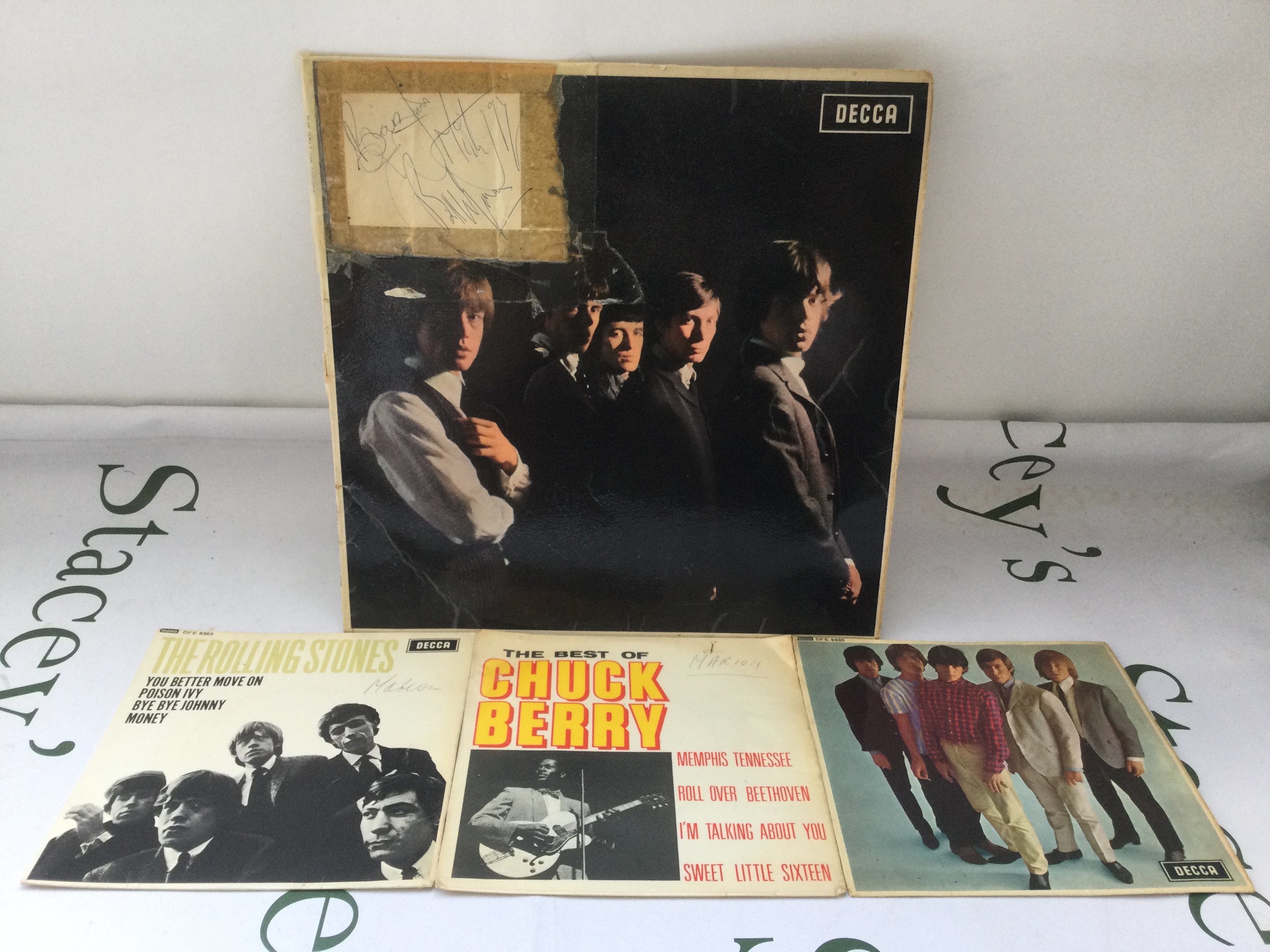 Three Rolling Stones autographs comprising Brian Jones, Mick Jagger and Bill Wyman signed in blue biro on paper sellotaped to an early UK pressing of the self titled debut LP together with two EPs and a Chuck Berry EP.