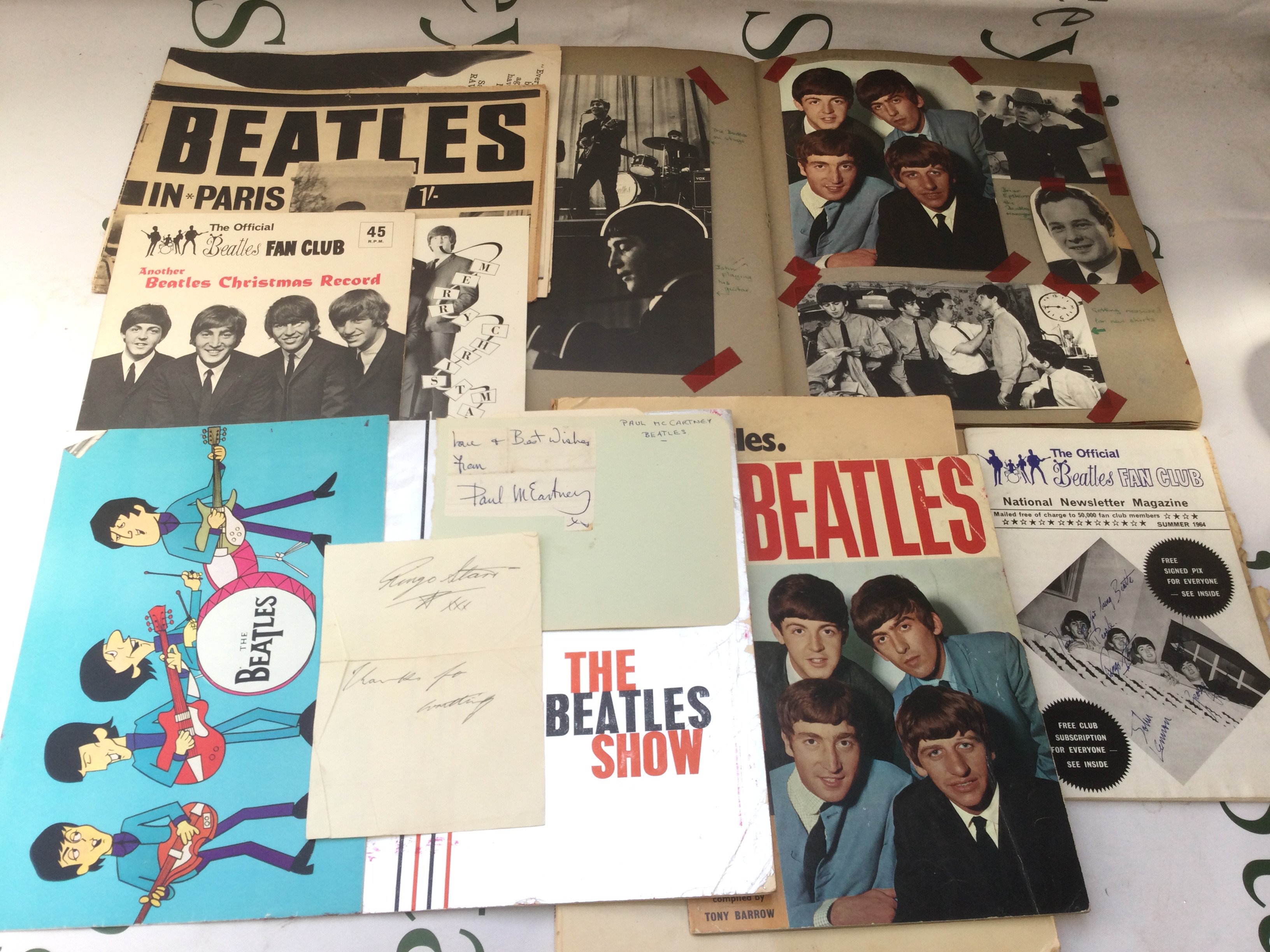 A collection of Beatles ephemera including Paul and Ringo's signatures, scrapbook, programs etc,