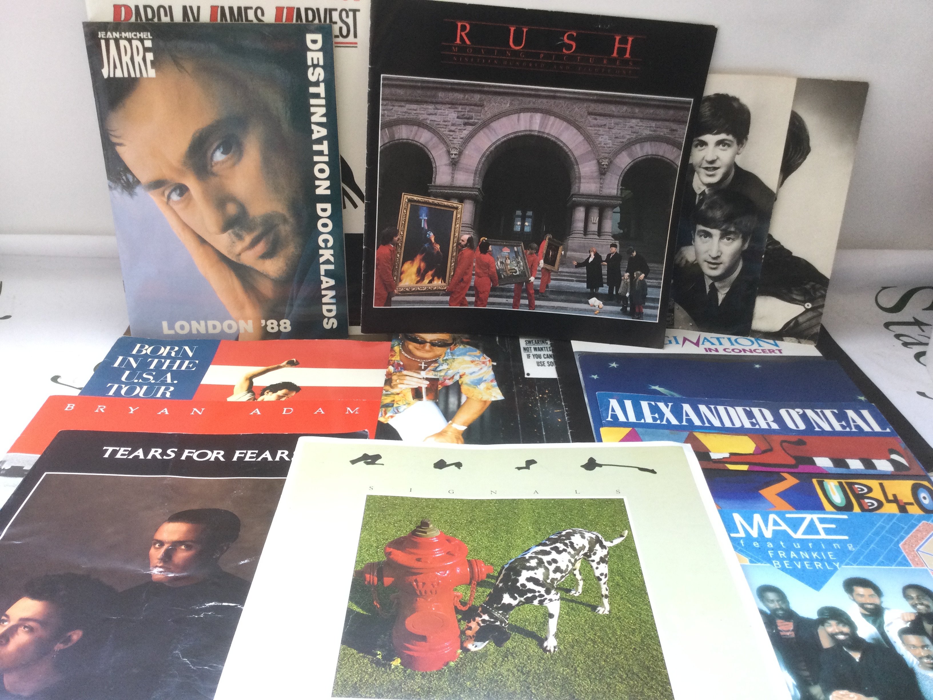 A collection of rock and pop music programs including some with tickets. Artists include Bruce Springsteen, Rush, Bryan Adams and others.