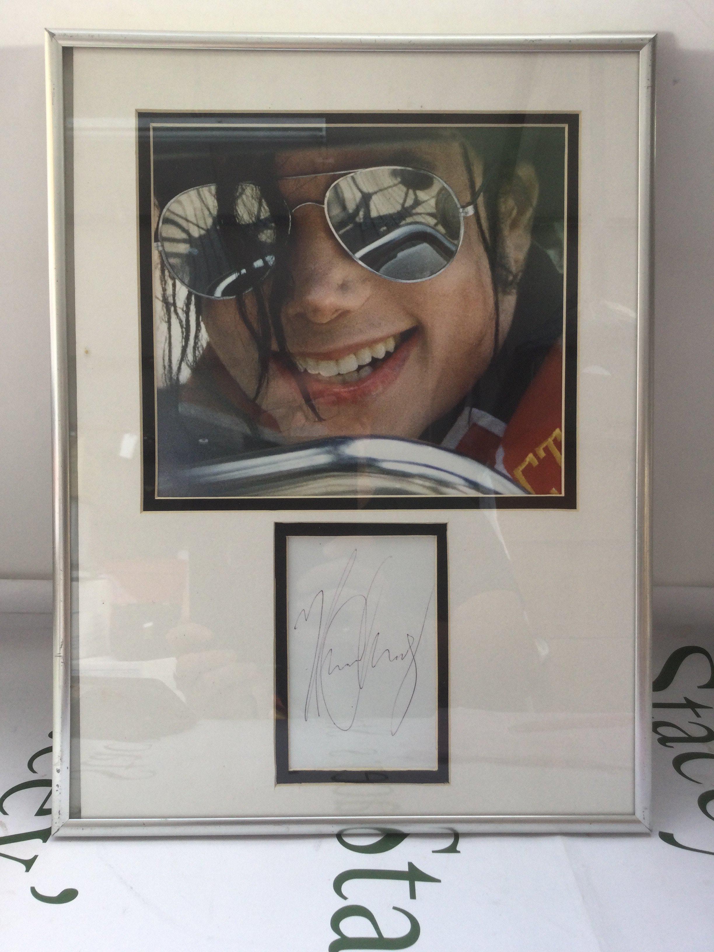A framed and glazed signed Michael Jackson display, approx 31cm x 41cm.