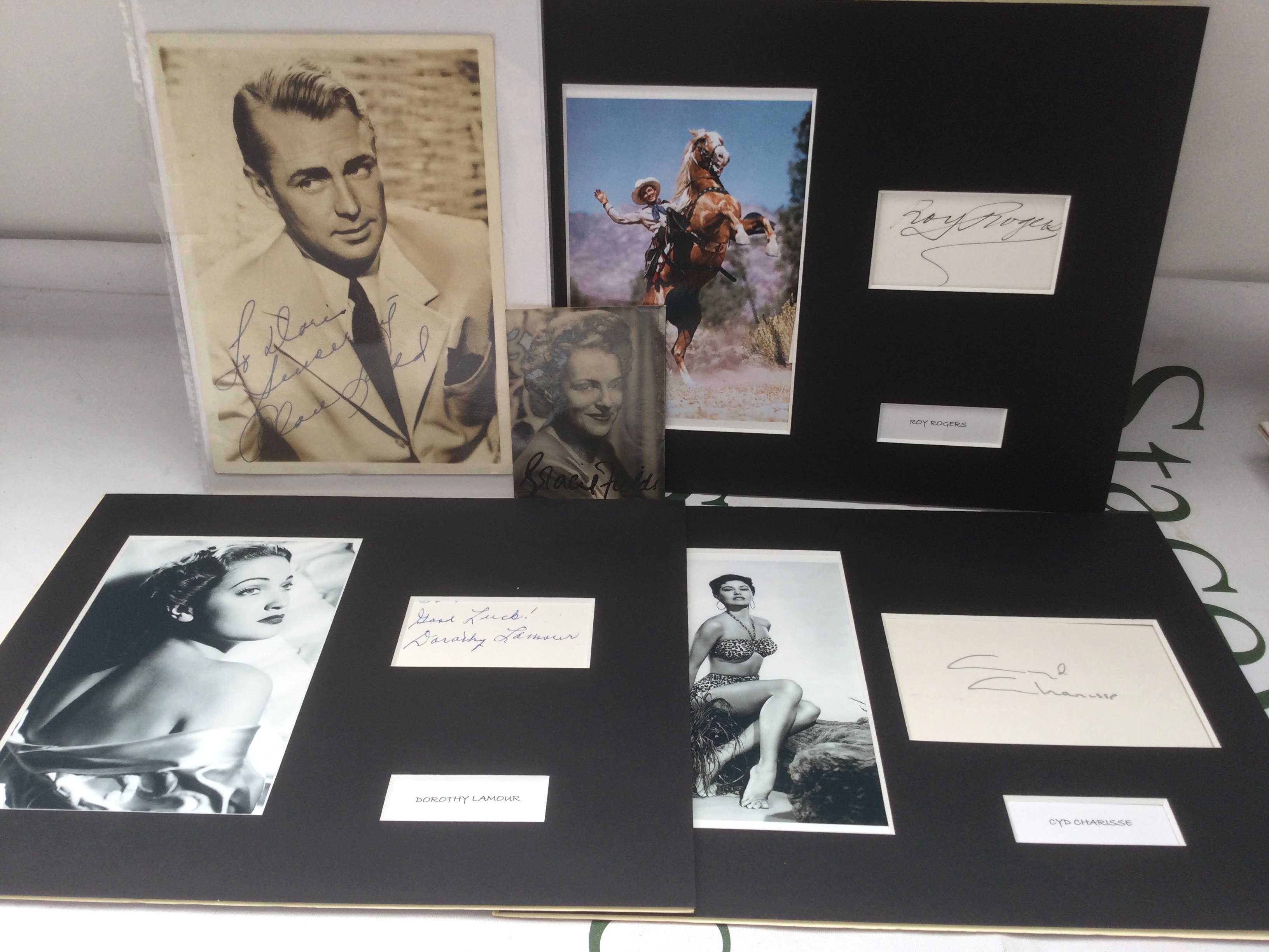 Five autographs comprising Roy Rogers, Gracie Fields, Alan Ladd, Dorothy Lamour and Cyd Charisse.