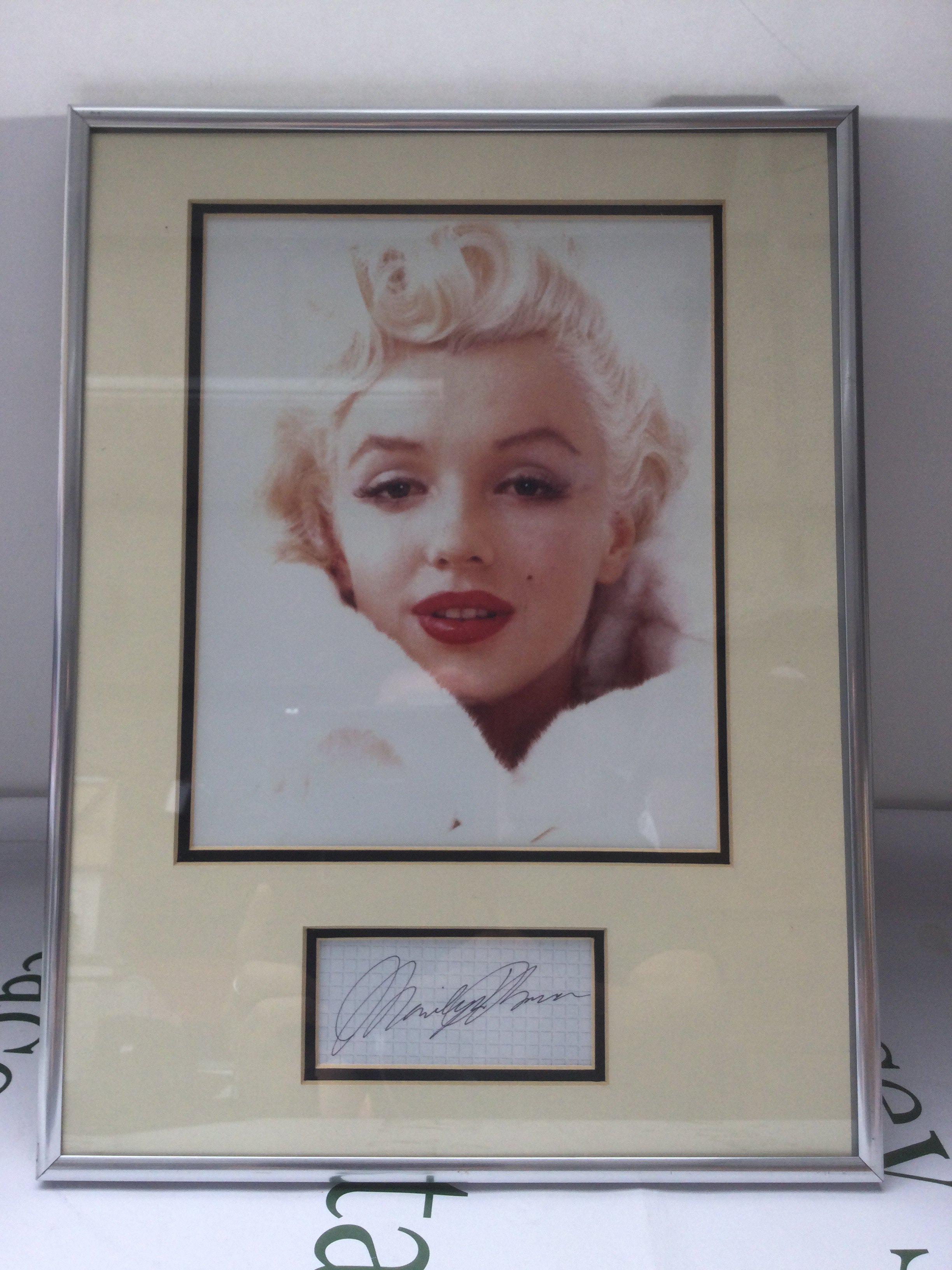 A framed and glazed signed display of Marilyn Monroe with COA, approx 32cm x 42cm.