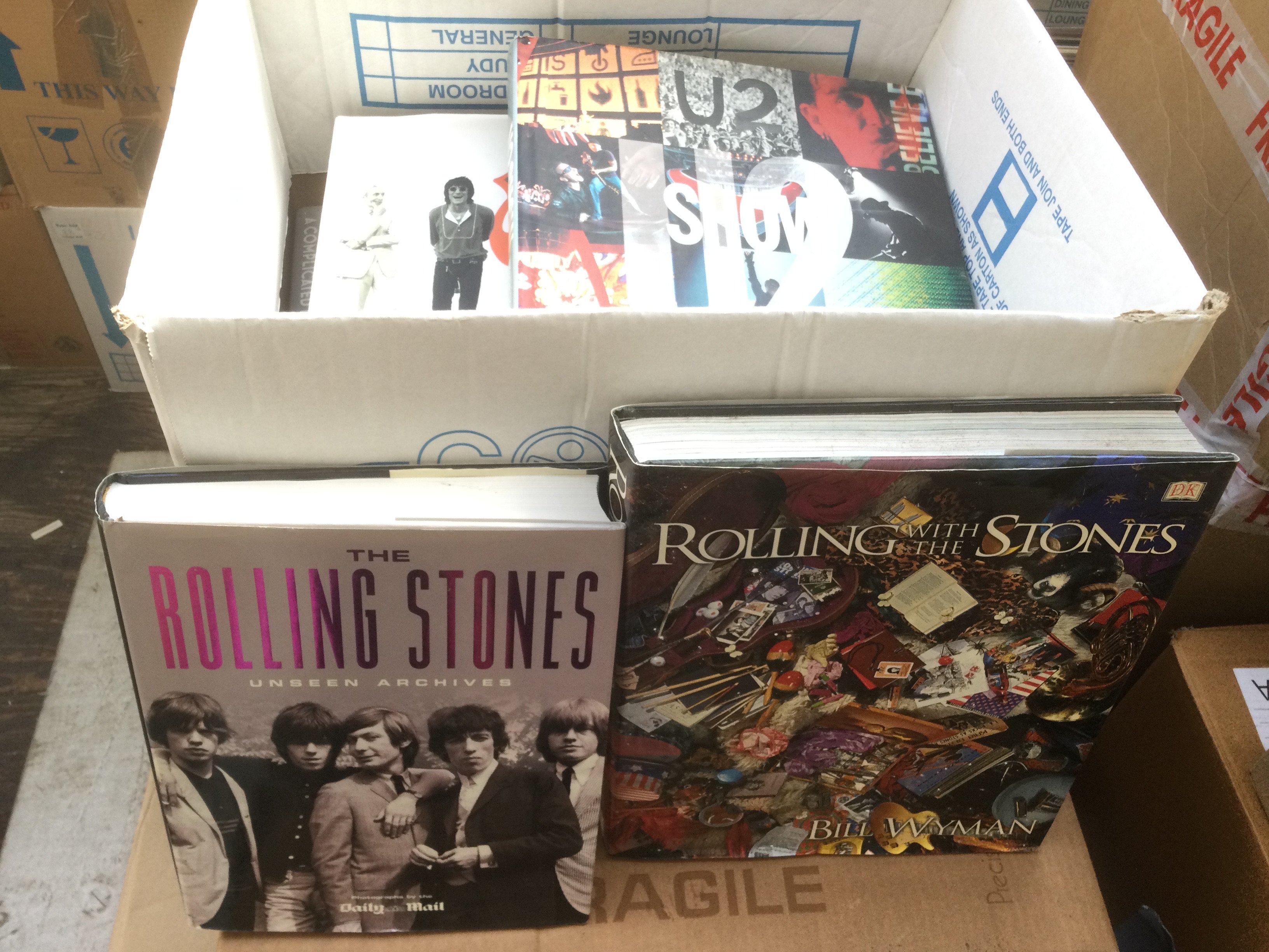 A collection of rock music books on various artists including The Rolling Stones, U2, The Kinks, The Who, David Bowie, Paul McCartney & Wings and Status Quo.