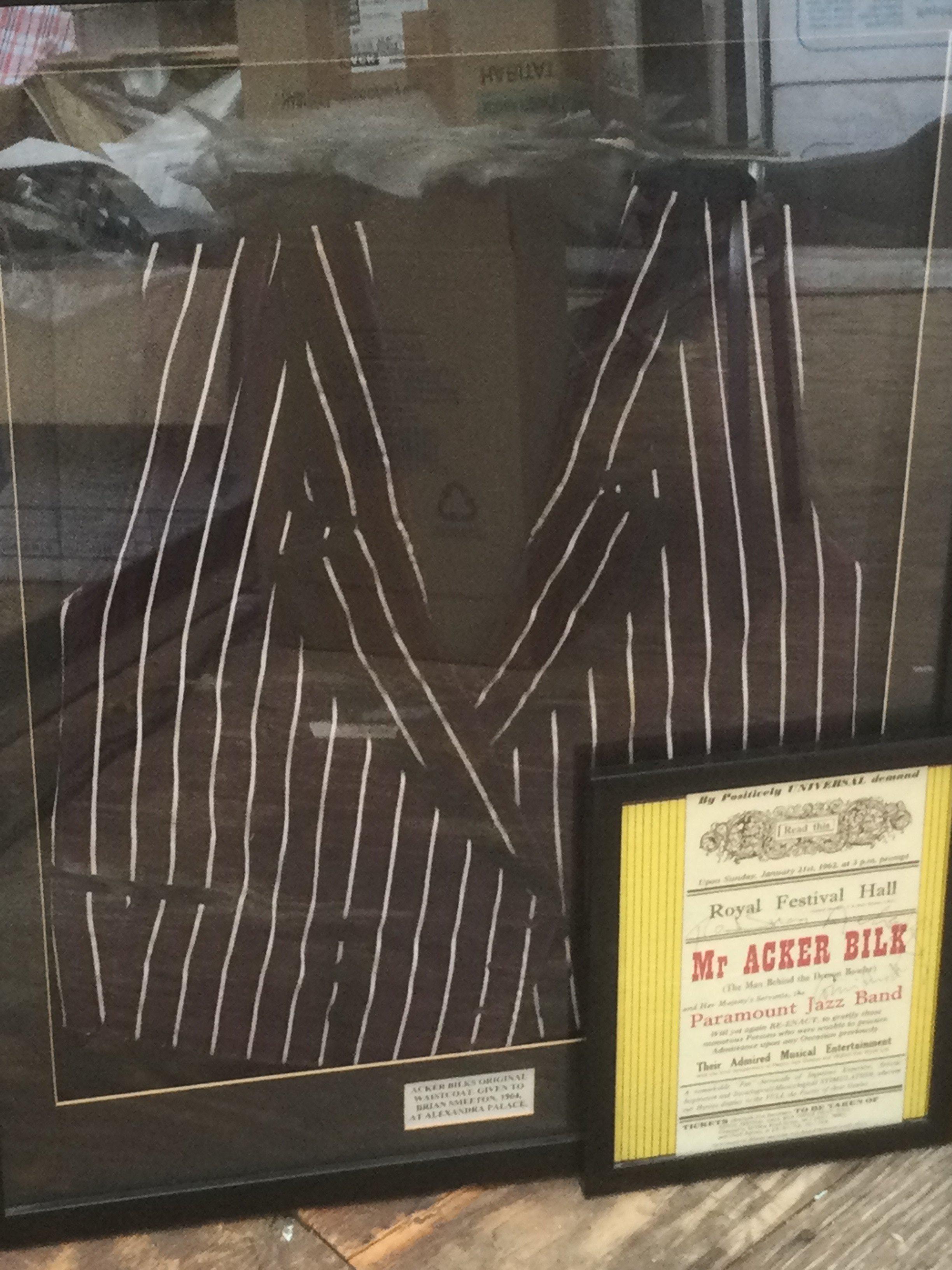 A framed and glazed stage worn waistcoat signed by Acker Bilk in 1964 together with a signed Acker Bilk program from 1962 (2).