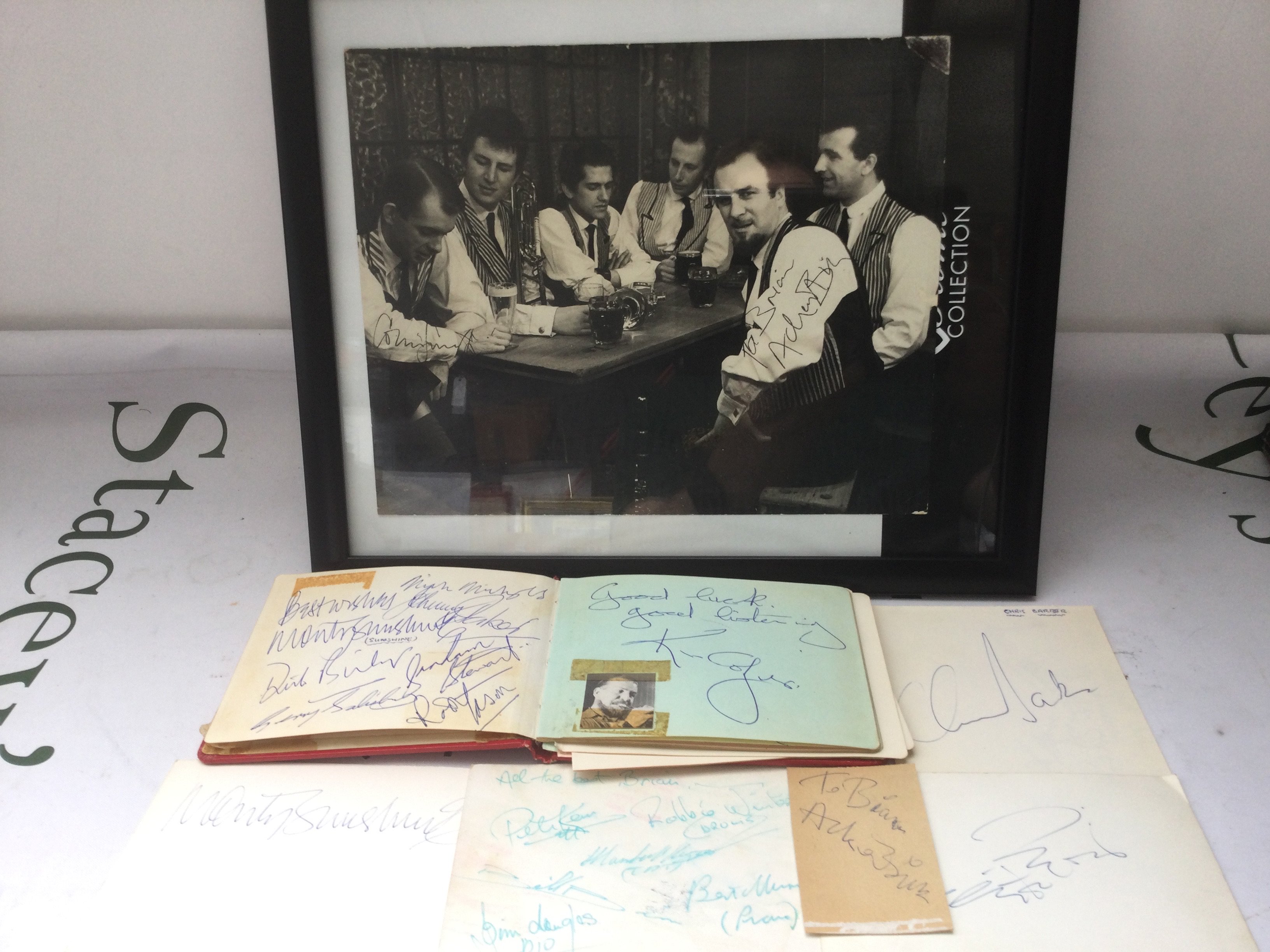 An autograph booklet containing various signatures including Monty Sunshine, Ken Collyer, Chris Barber and others plus a signed photo of Acker Bilk and his band.