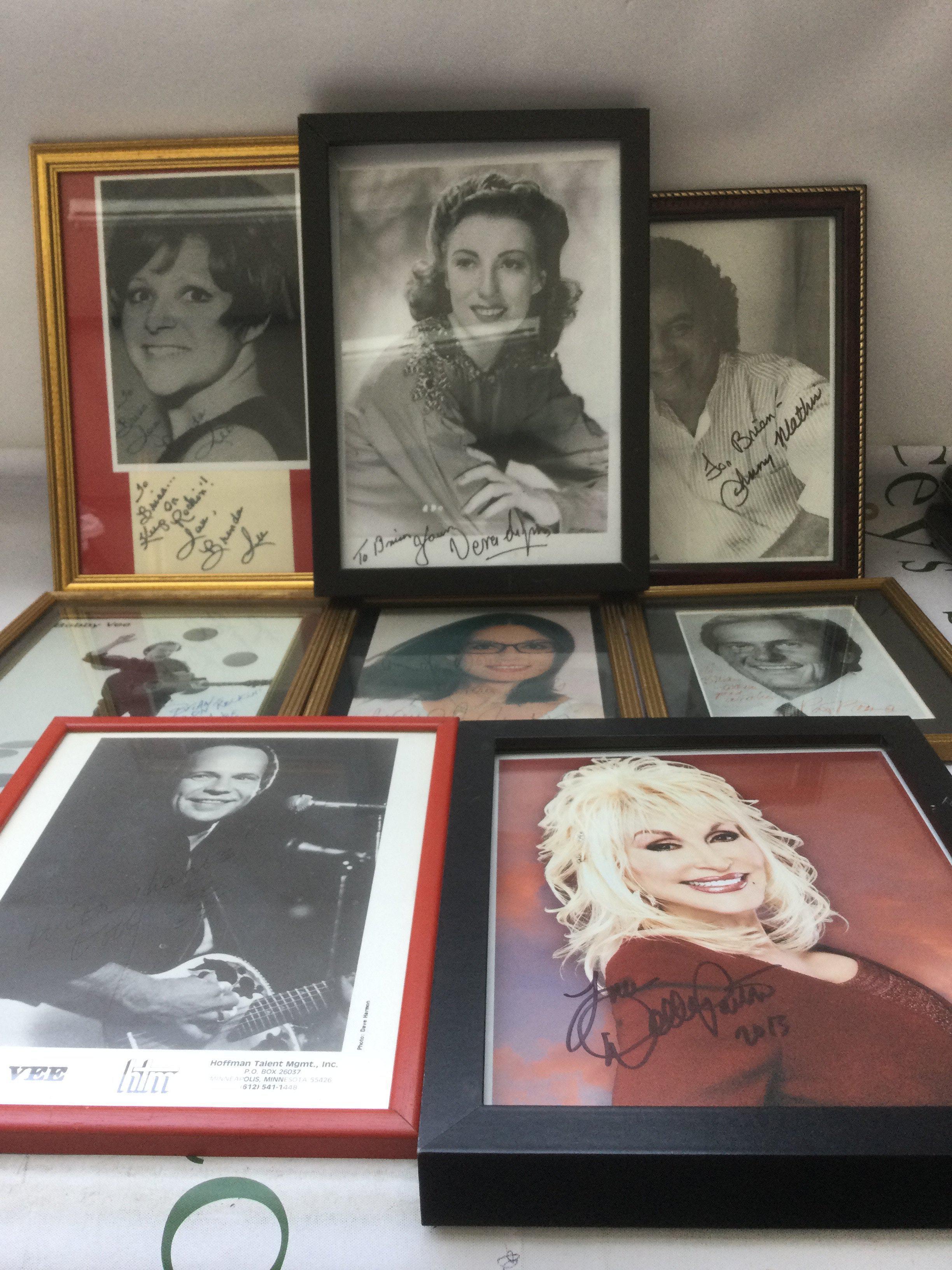 A collection of signed and framed photos of musicians and singers including Dolly Parton, Bobby Vee, Brenda Lee and others.