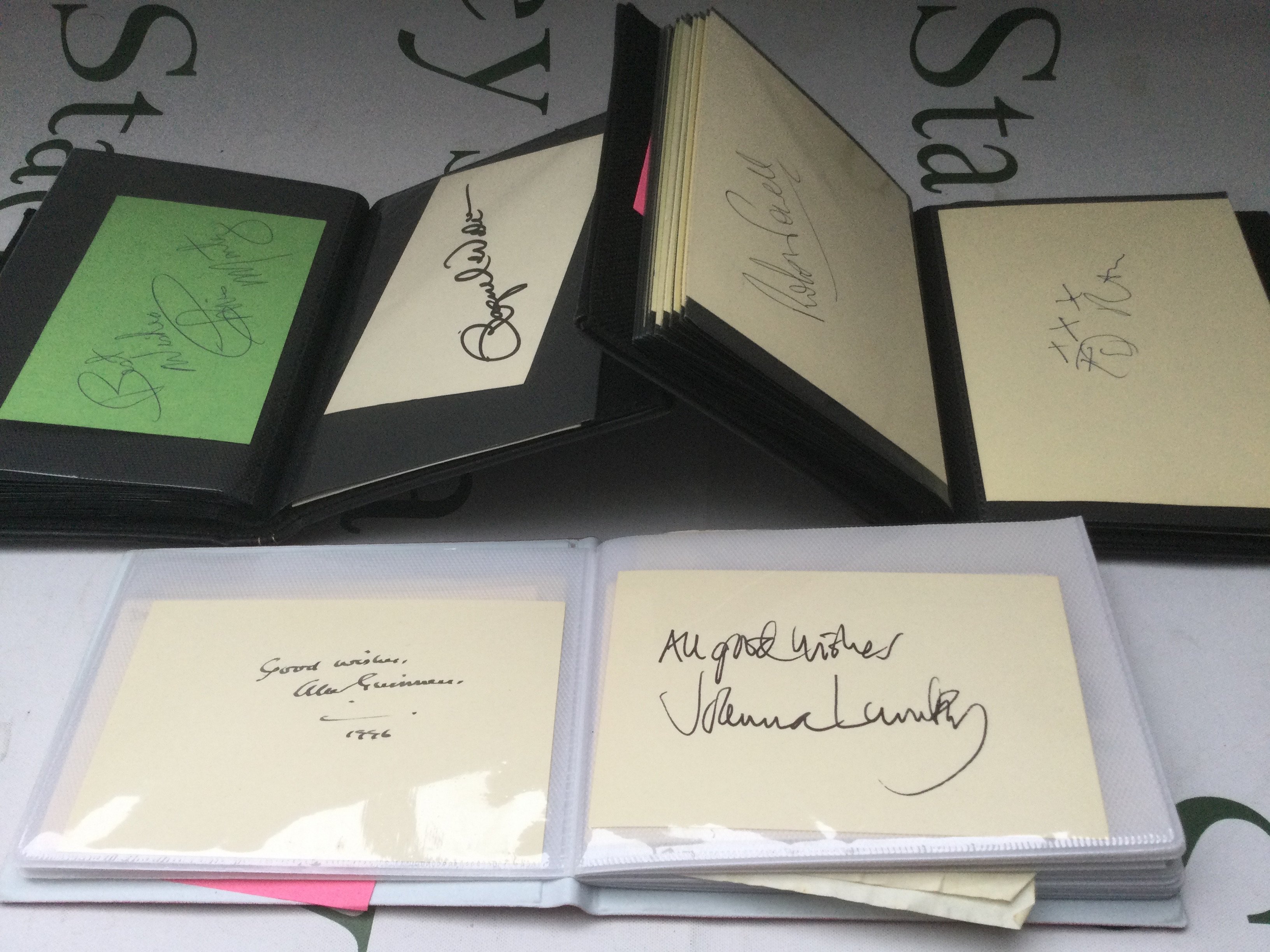 Three autograph booklets containing many signatures including Alec Guiness, Joan Collins, Robert Redford, Donald Sutherland, Debbie Reynolds, Racquel Welch and many more. Please see images for a more detailed list.