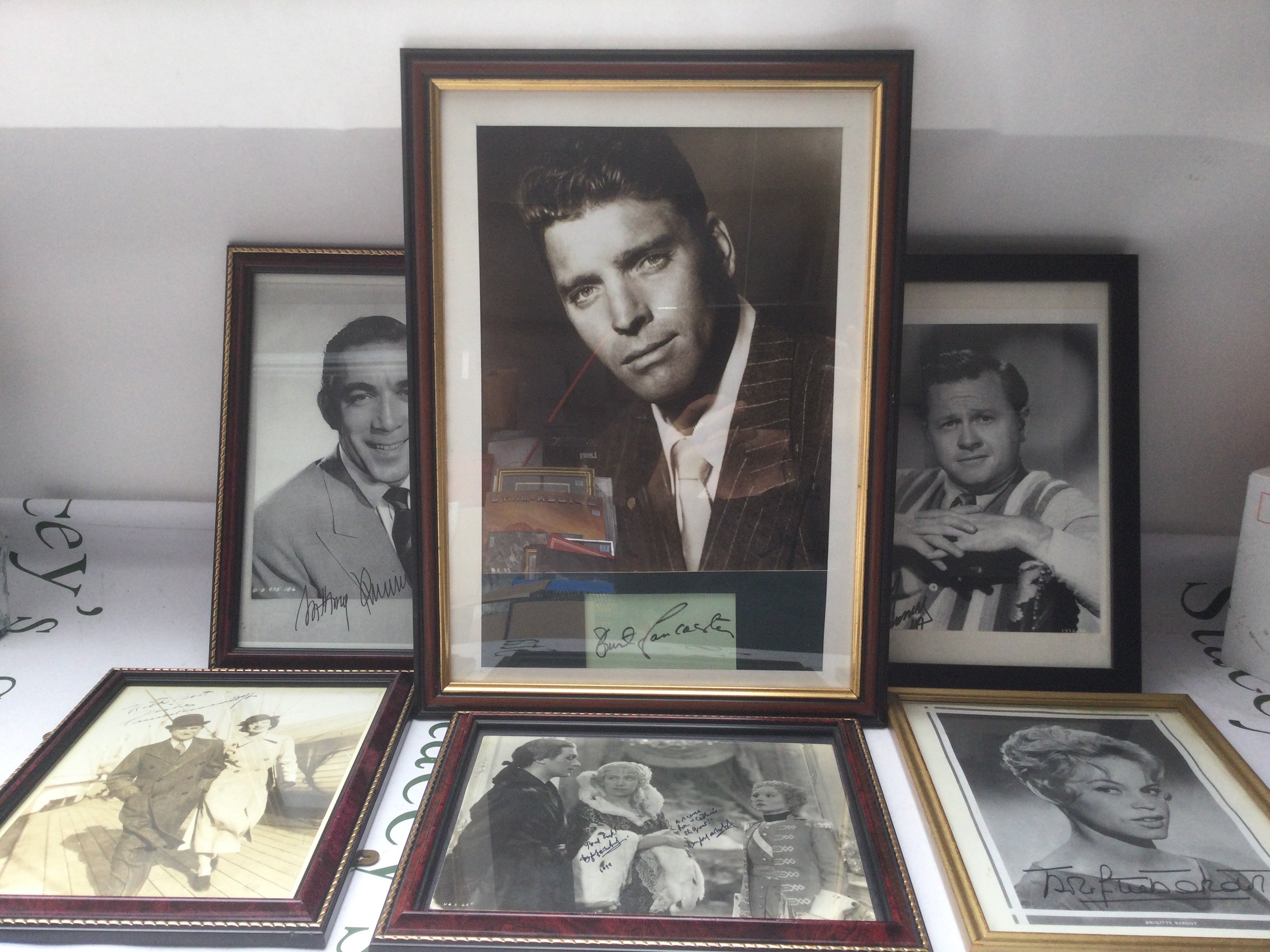 Six framed and signed photos comprising Burt Lancaster, Anthony Quinn, Brigitte Bardot and others.