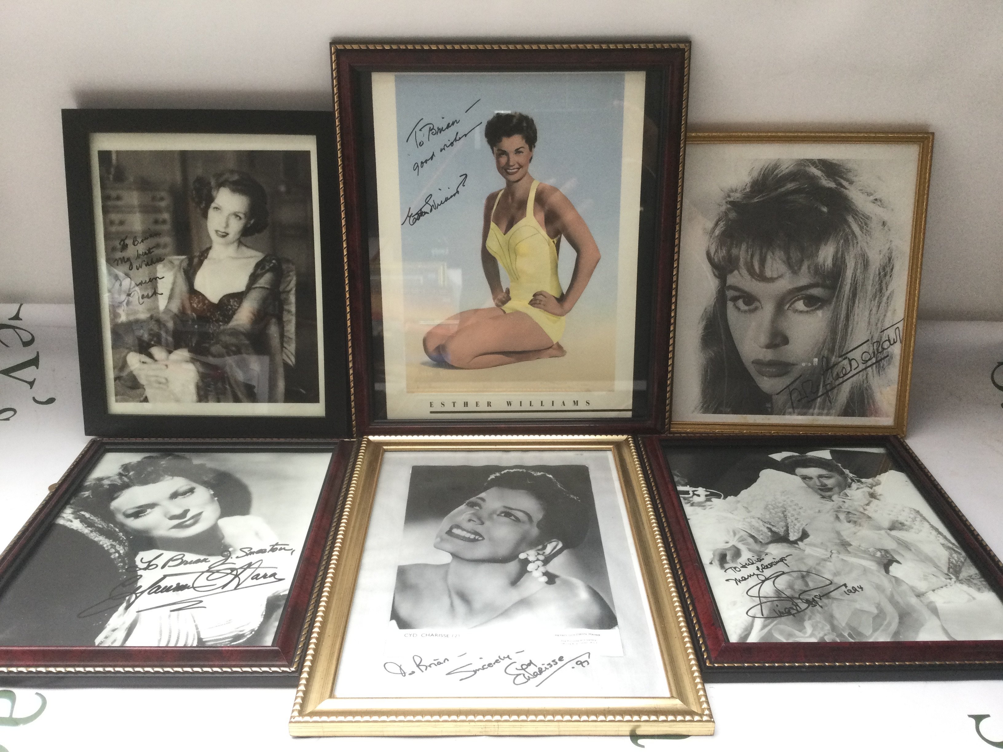 A collection of framed and signed photos of Maureen O'Hara, Cyd Charisse, Esther Williams and others.