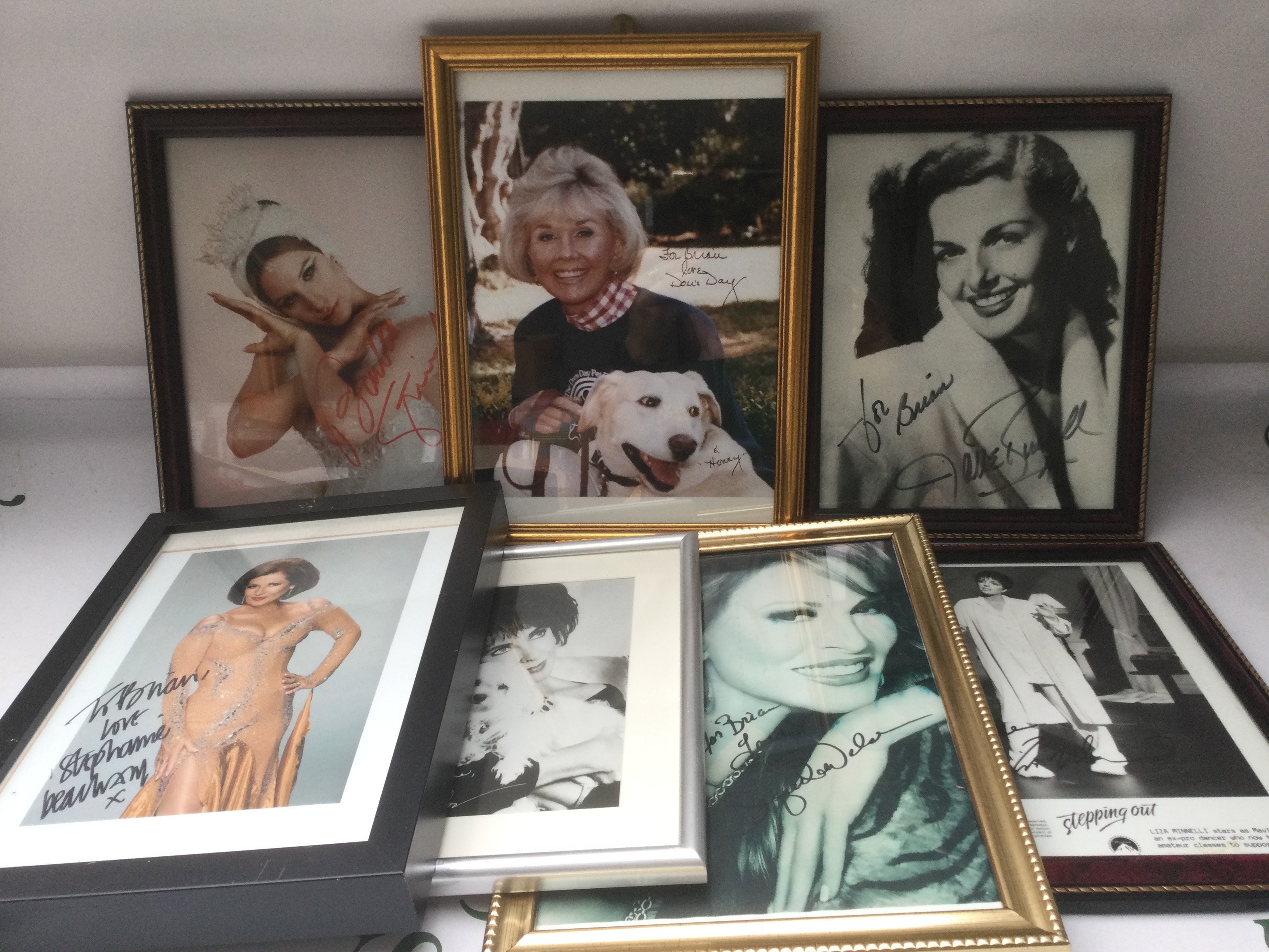 A collection of signed photos comprising Mary Pickford, Doris Day, Liza Minelli, Racquel Welch and others plus a printed signature of Elizabeth Taylor.