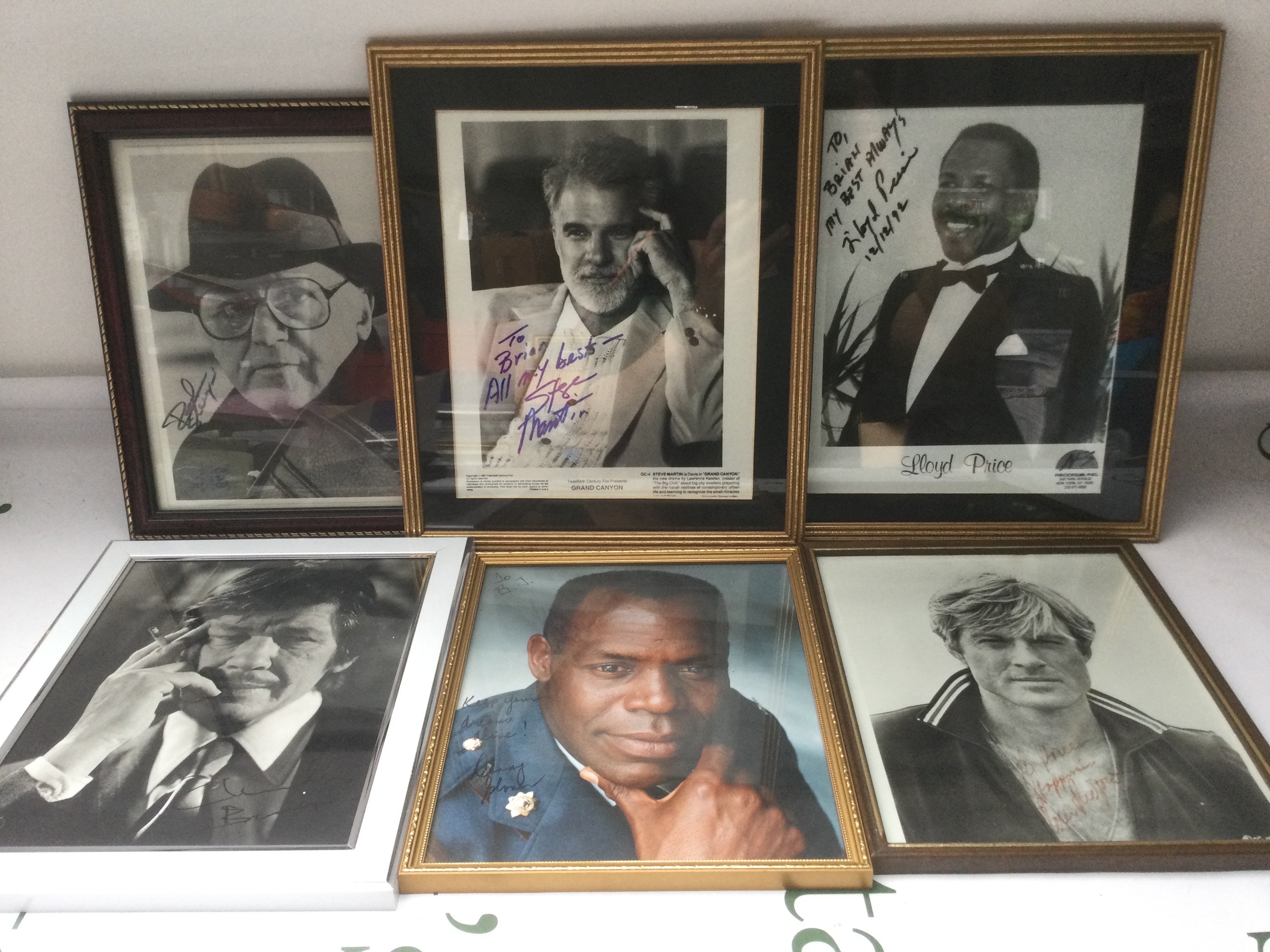 Six framed and signed photos of Robert Redford, Rod Steiger, Steve Martin and others.