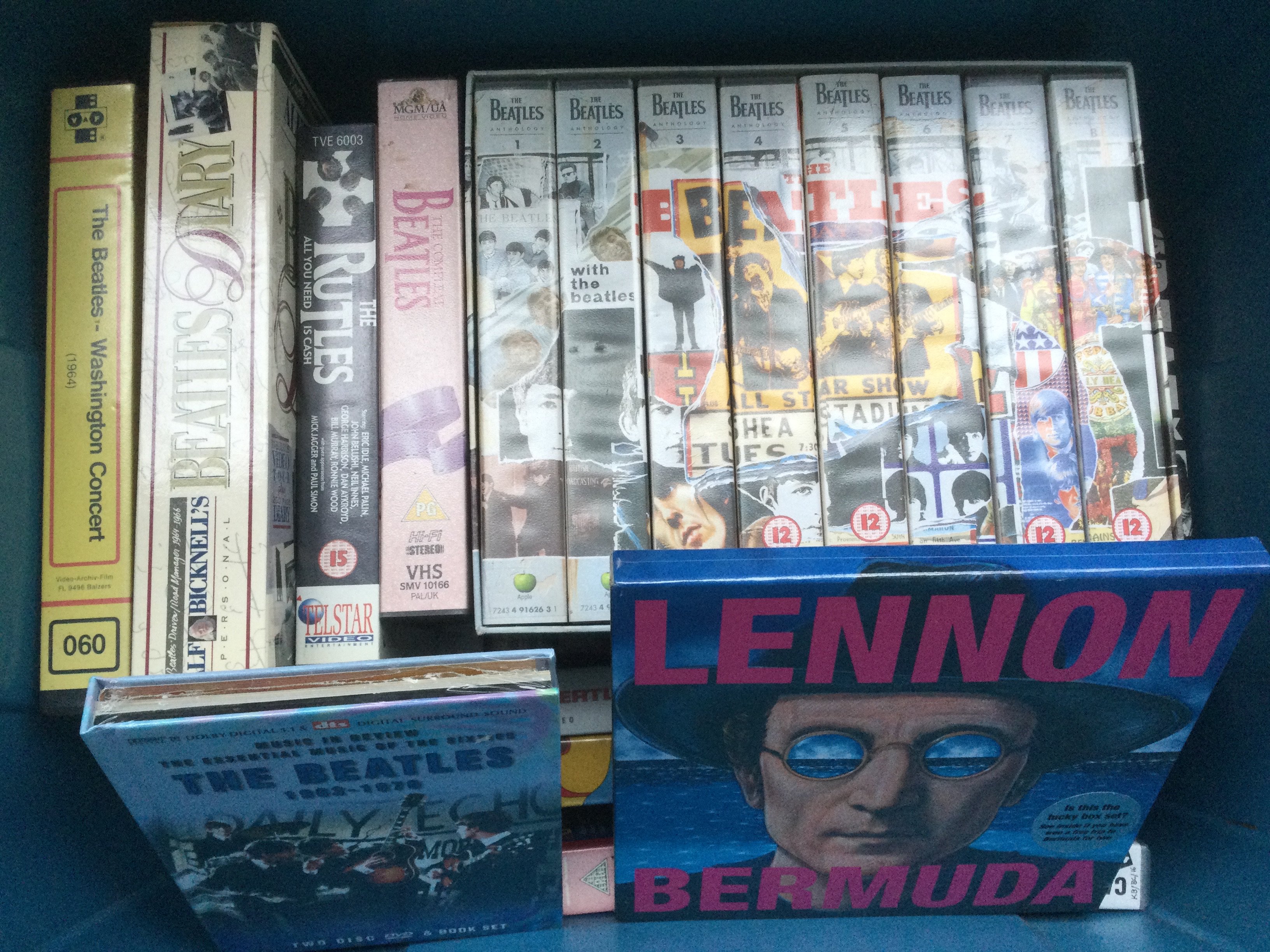 Two boxes of Beatles related DVDs, VHS tapes, fan club magazines etc.