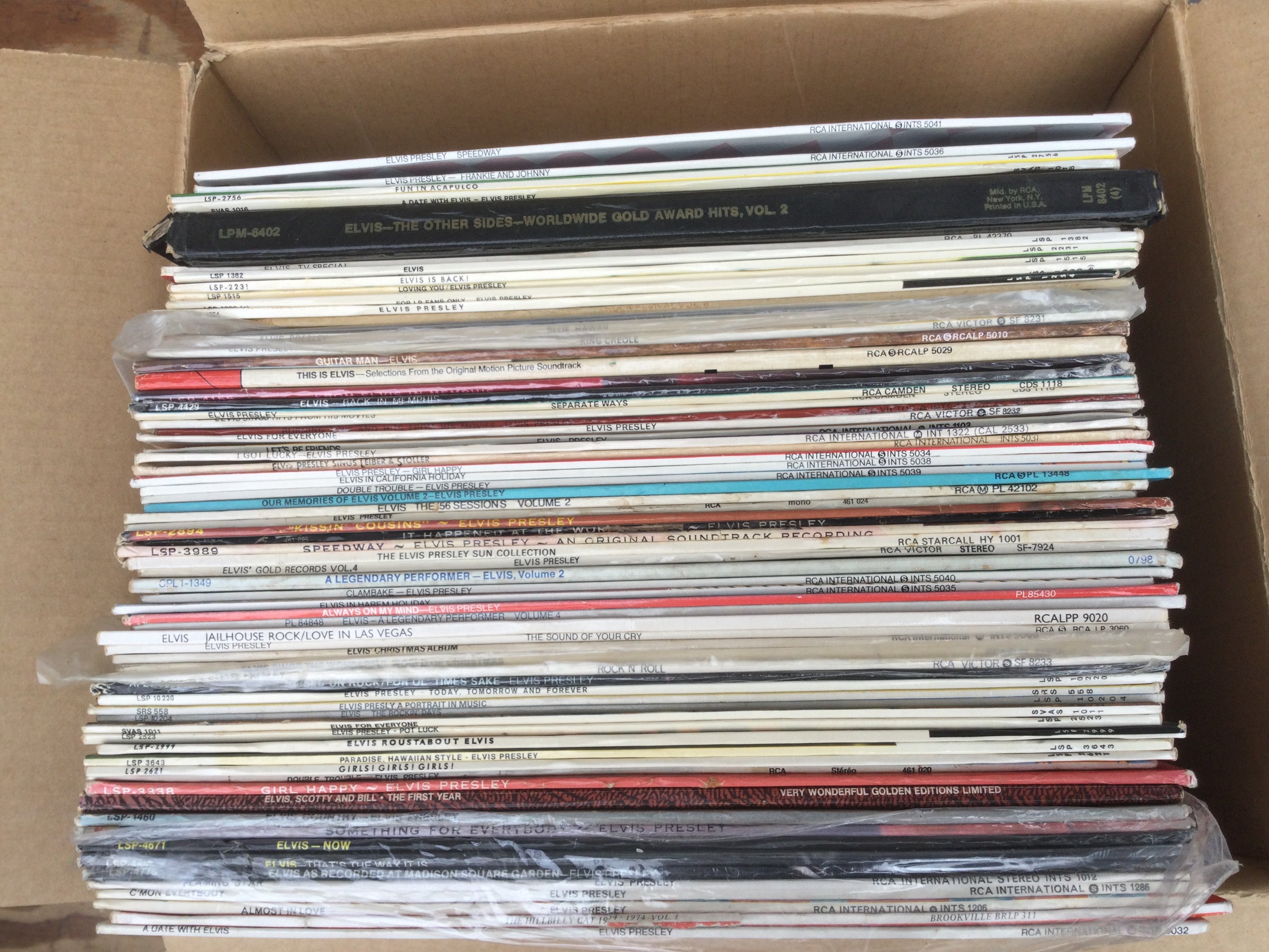 A box of Elvis Presley LPs.