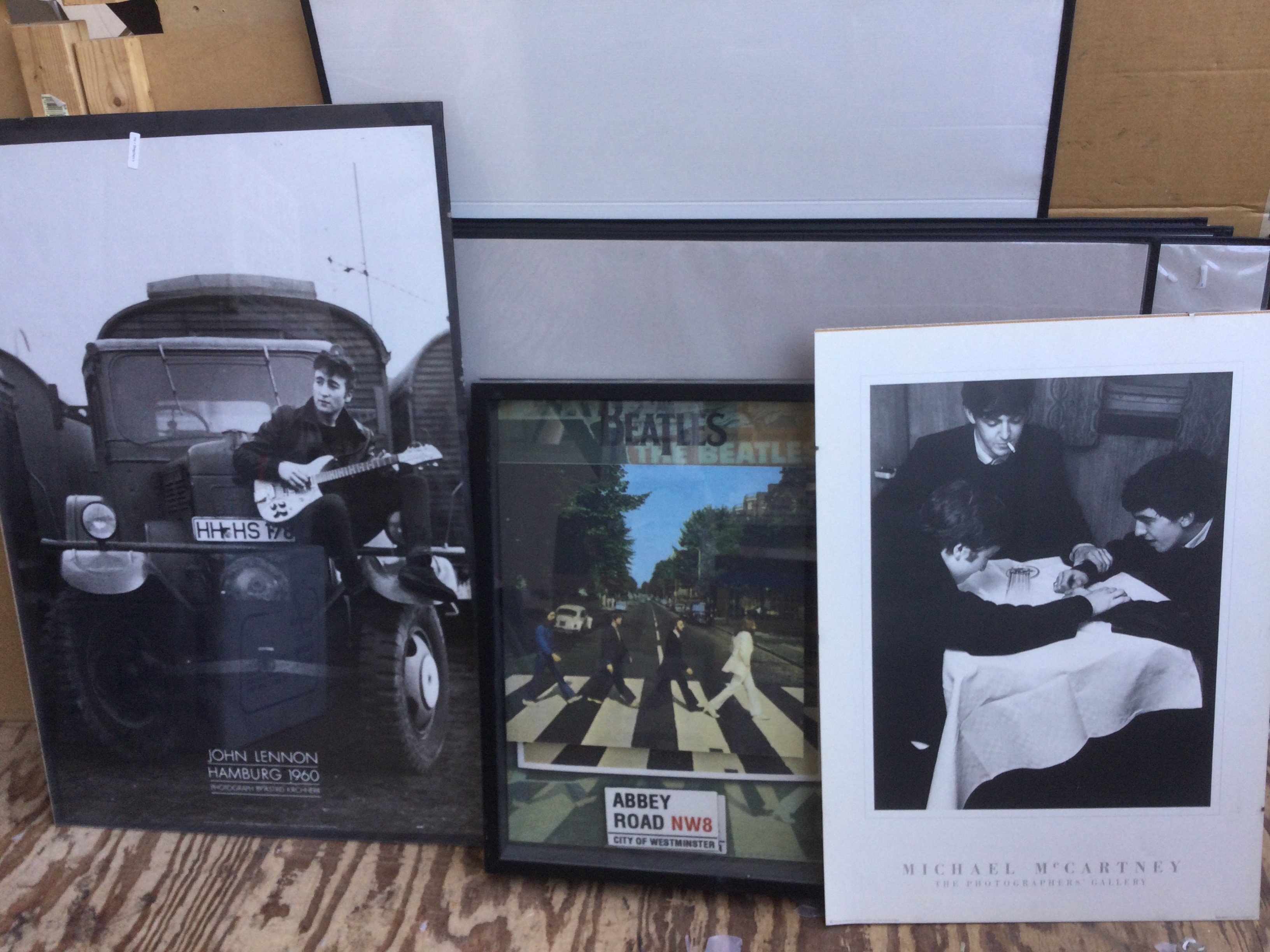 A framed and signed Paul and Linda McCartney montage plus three Beatles posters (4).