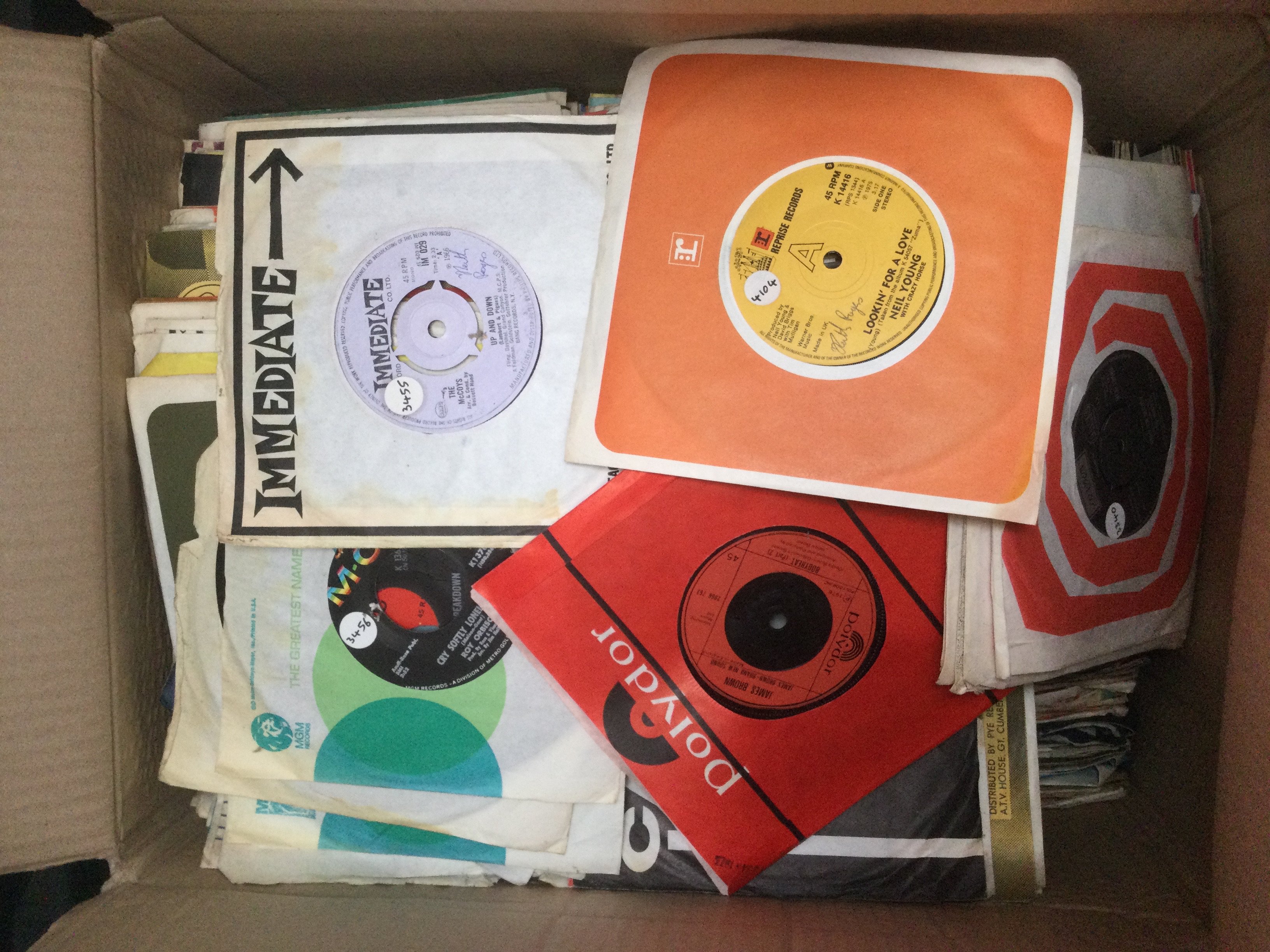 Two boxes of 7" singles by various artists including Sex Pistols, David Bowie, The Stranglers and many more.