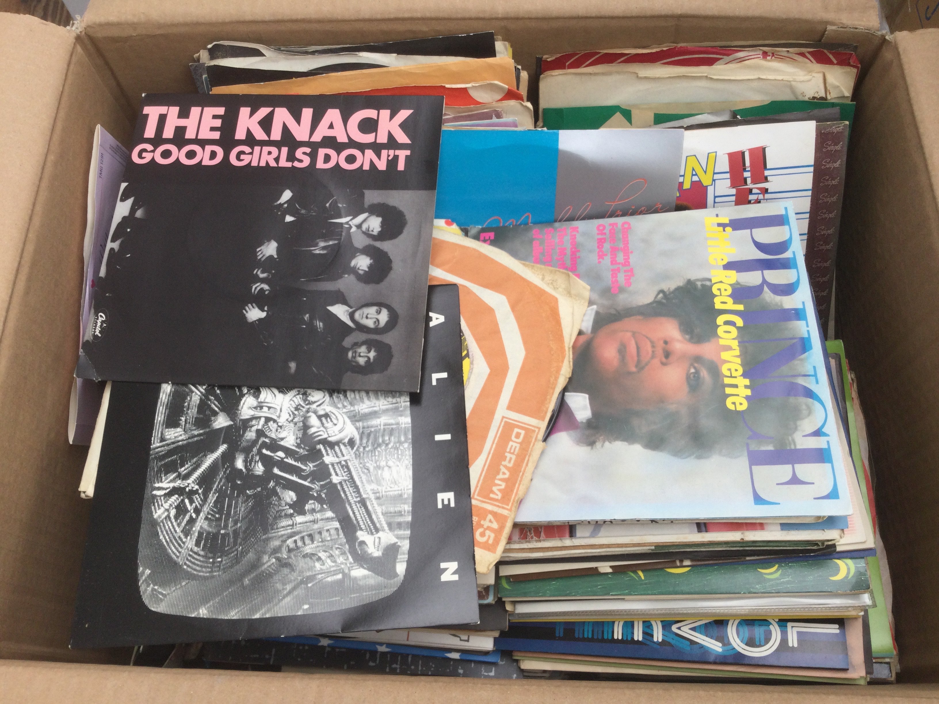 Two boxes of 7" singles by various artists including Prince, Vanilla Fudge, The Ramones and many more.
