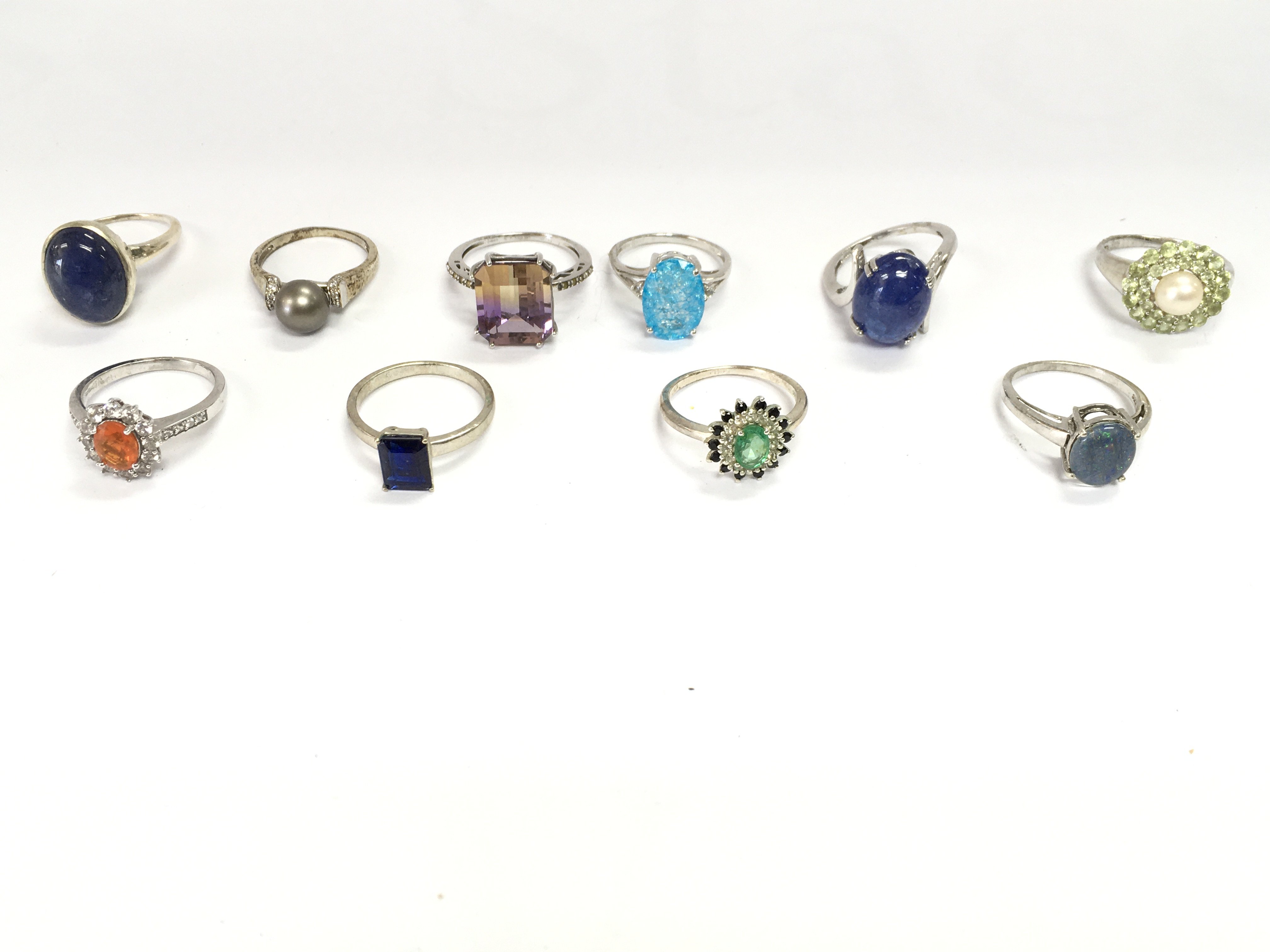 A collection of 10 assorted silver rings set with various stones. Postage B