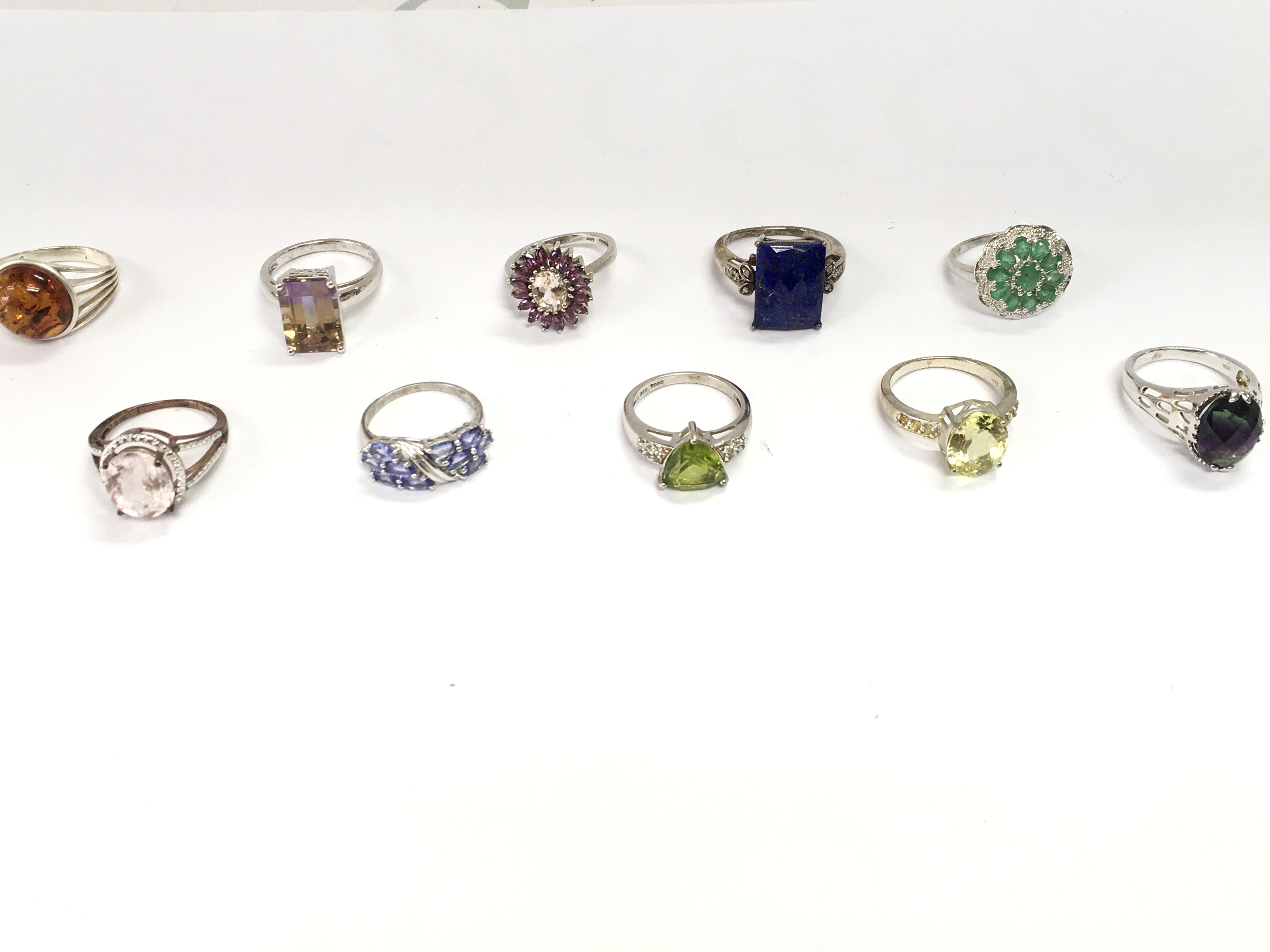 A collection of 10 assorted silver rings set with various stones. Postage B